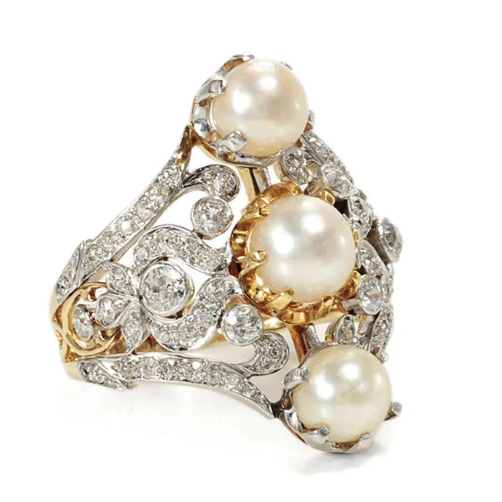 Simply Beautiful! Finely detailed 3 Pearl and Diamond Navette Lacey Platinum Cocktail Ring. Securely Hand set with 3 Pearls, surrounded by approx. 1.10tcw Old European Cut Diamonds. Hand crafted Platinum on 14K Gold mounting. Ring size 9; we offer