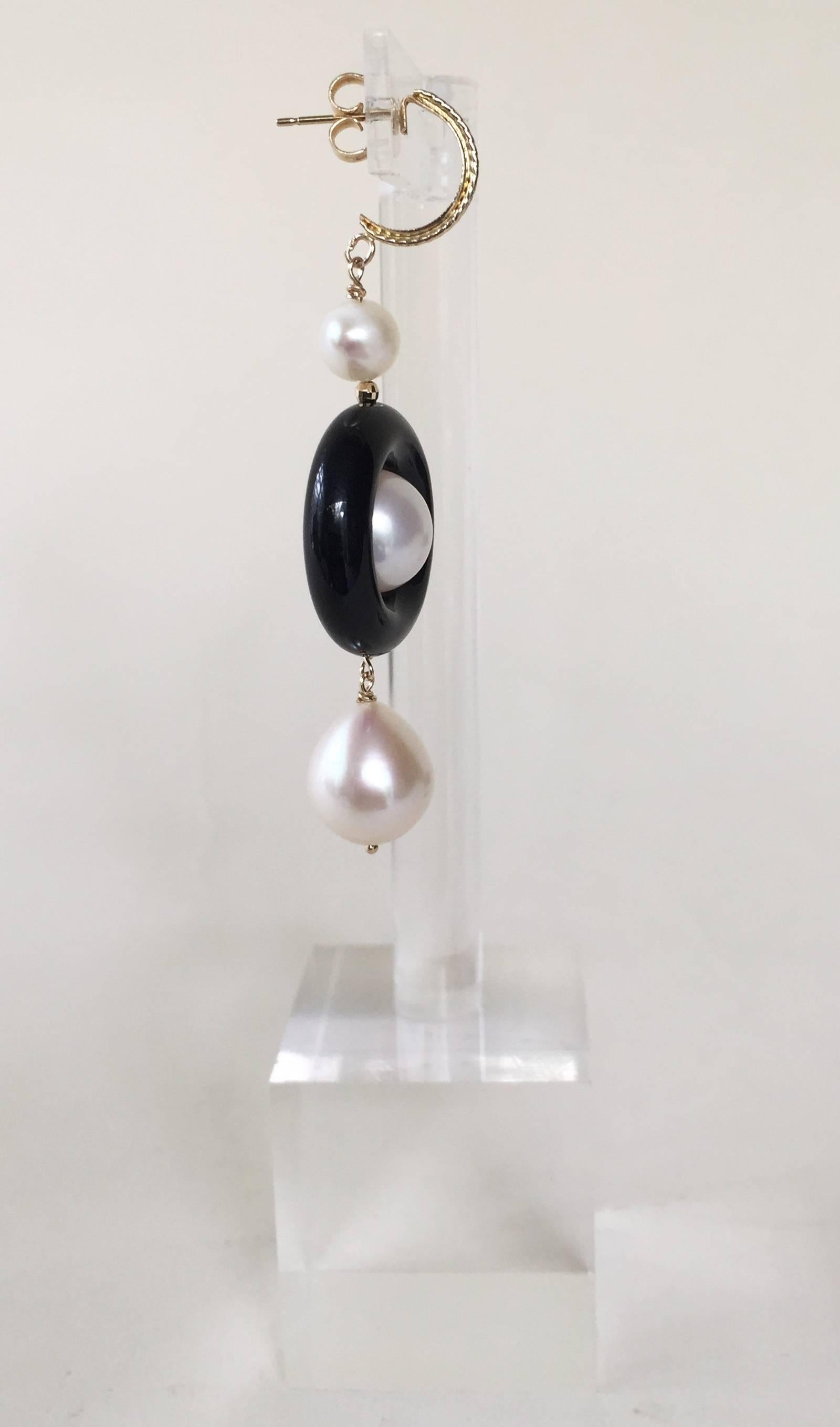 Bold pair of Black and White Earrings by Marina J. This striking pair features high luster White Pearls and Black Onyx. Measuring 2.4 inches each, this dramatic Art Deco inspired pair hangs off solid 14k Yellow Gold textured Round Studs.

** For any