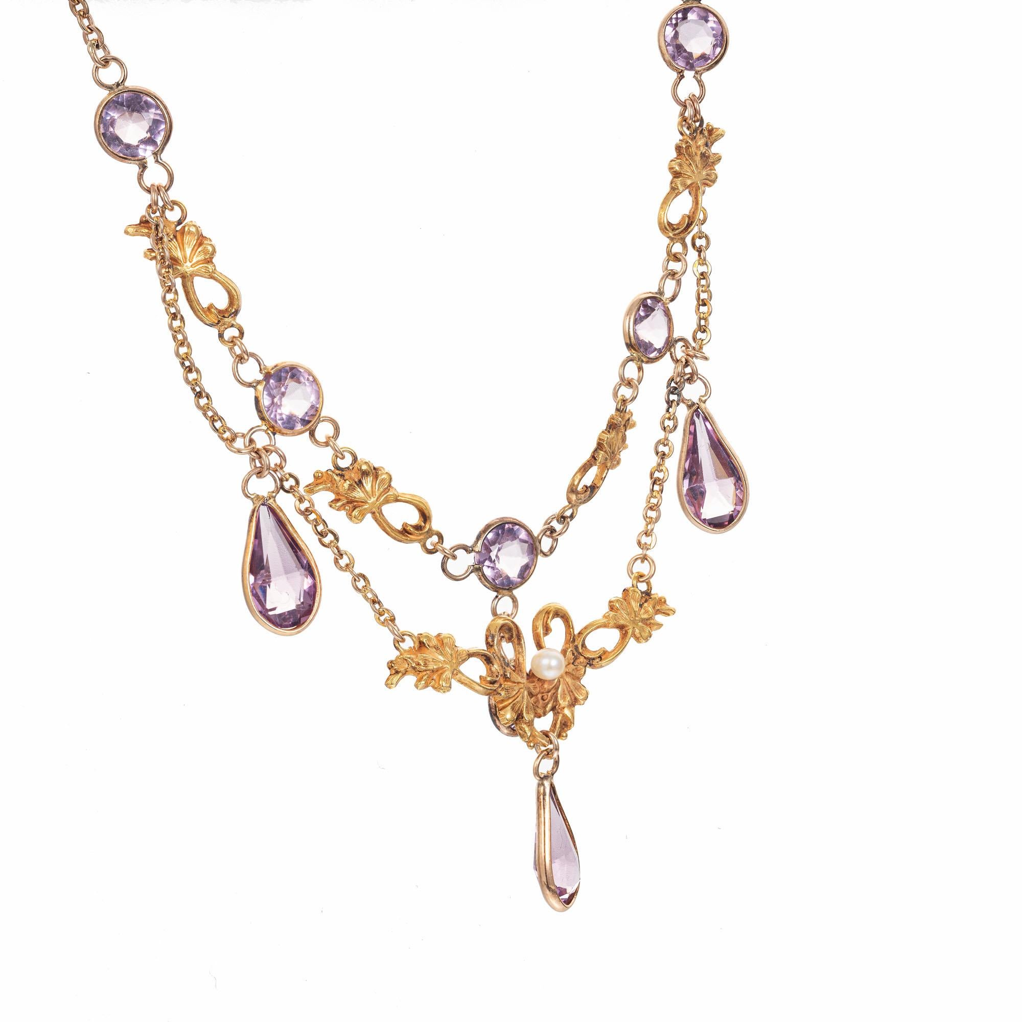 Victorian, 1900's Pearl and amethyst drop necklace.  5 round amethysts with 3 pear shaped amethyst dangles. in 14k yellow gold with one round center pearl. 18.5 inches in length. 

One 2.7mm natural pearl
5 round Amethyst, approx. total weight
