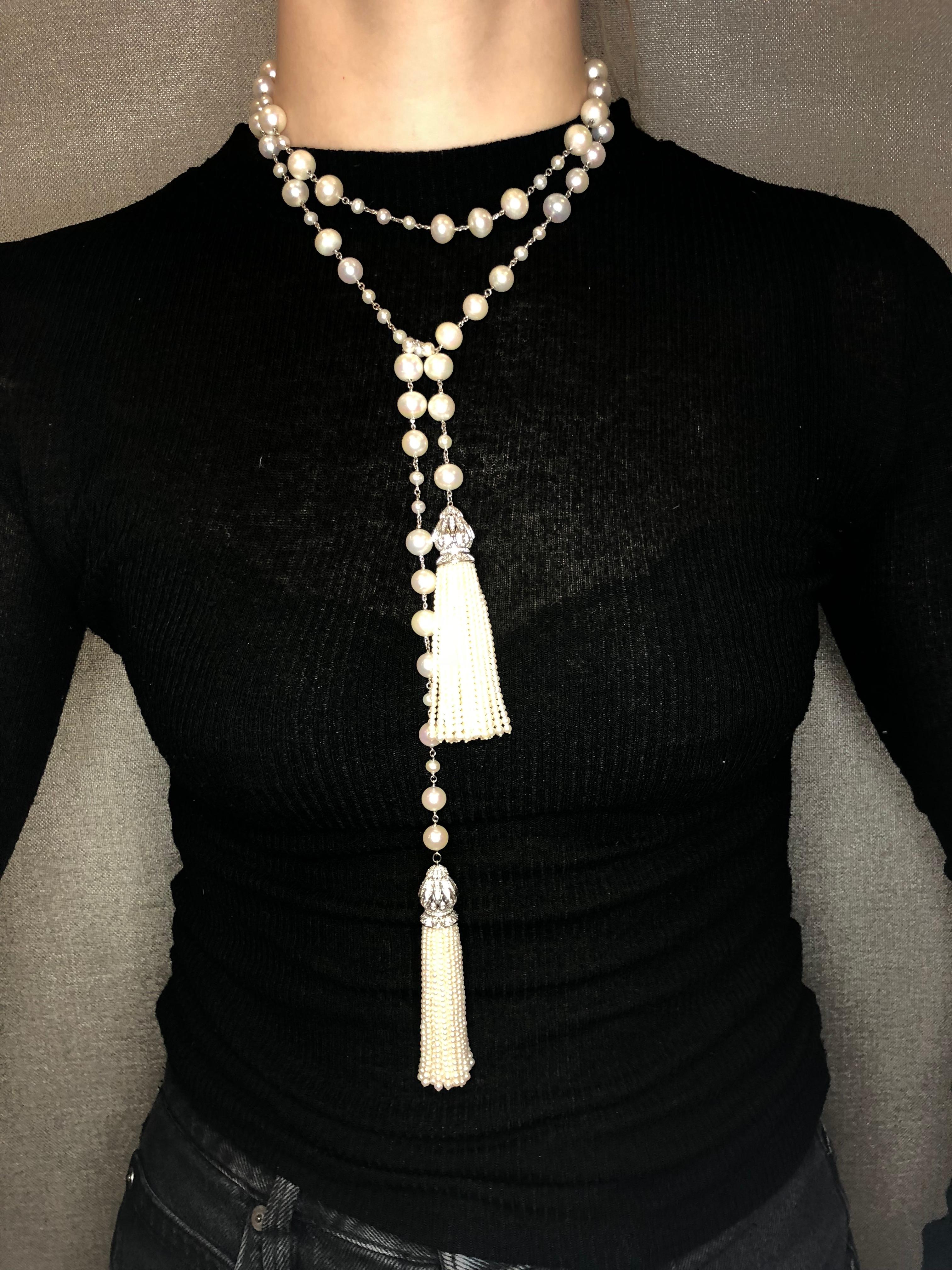 A beautiful and versatile Tassel Necklace with hand strung natural freshwater pearl tassels finished with 18k White Gold Caps set with 344 Diamonds for a total of 2.80 Carats. The 18k White gold and freshwater pearl chain is 44 inches long and the