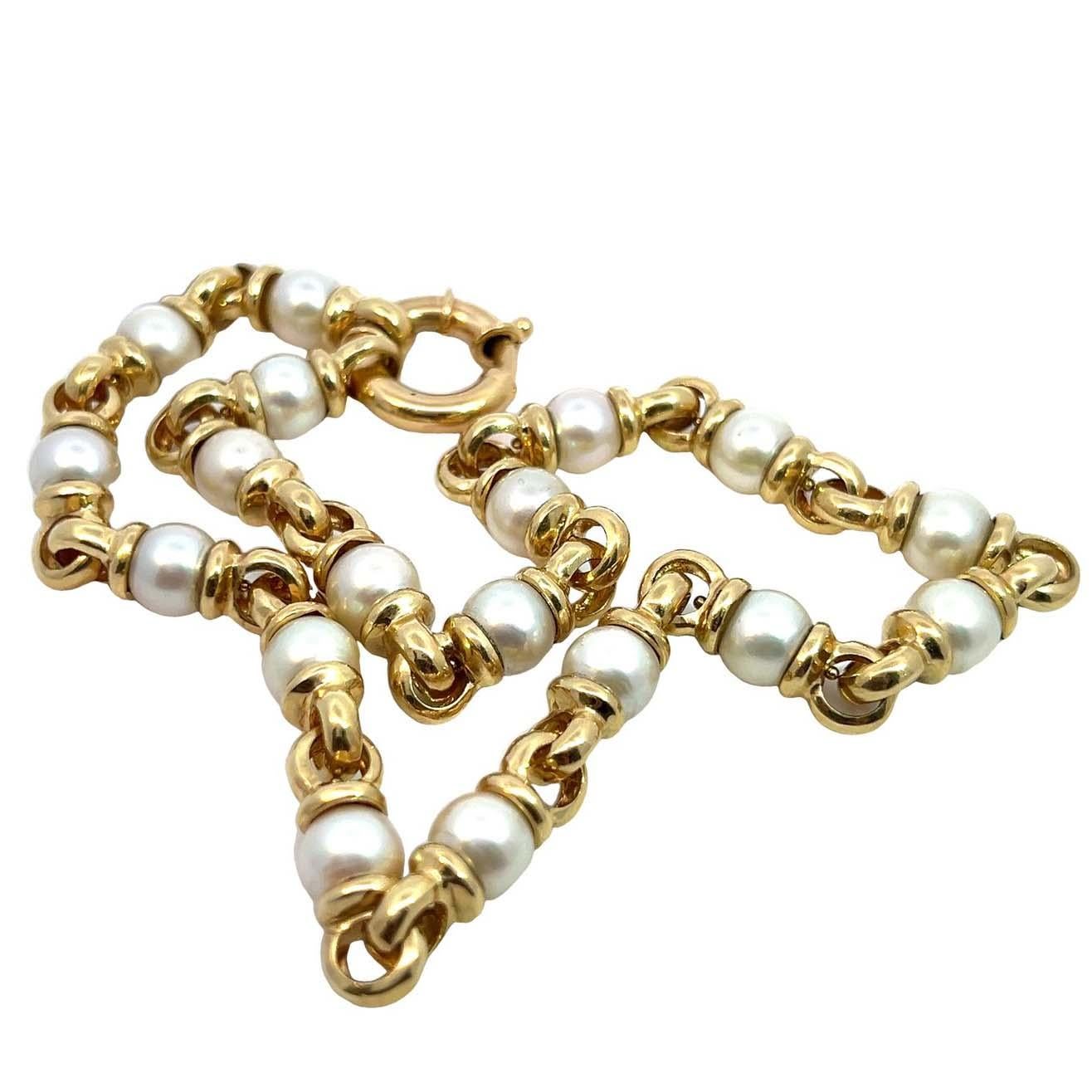 Pearl and Yellow Gold Link Necklace. Crafted from 14-karat yellow gold, this 15-inch necklace features 18 lustrous pearls interspersed with polished gold links. This timeless design elevates any ensemble and is a versatile staple for any discerning