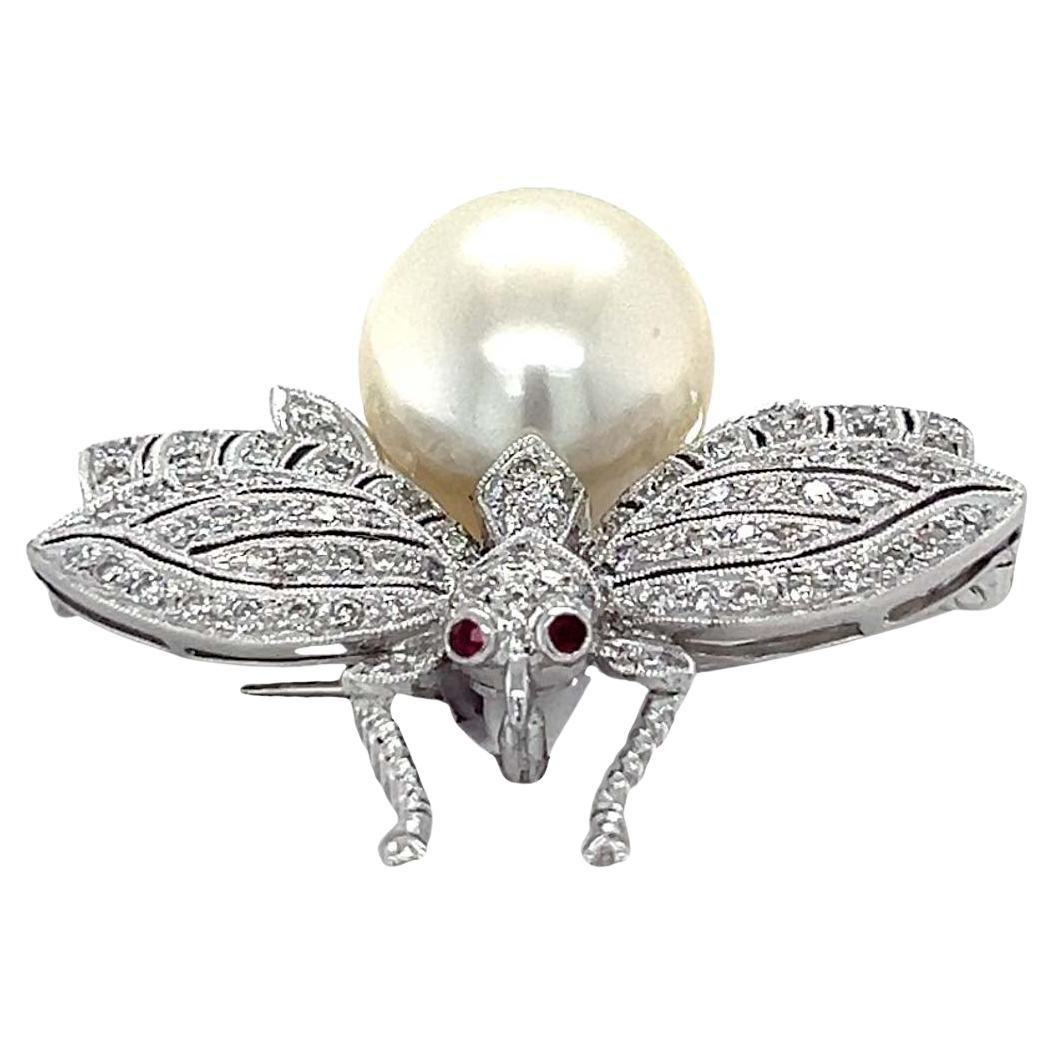 Large pearl and diamond brooch in 18-karat white gold. Gracefully spread over the bee's wings are 0.71 carats of diamonds. This timeless brooch featuring a lustrous pearl body is set in 18-karat white gold. 
This brooch is sure to be 