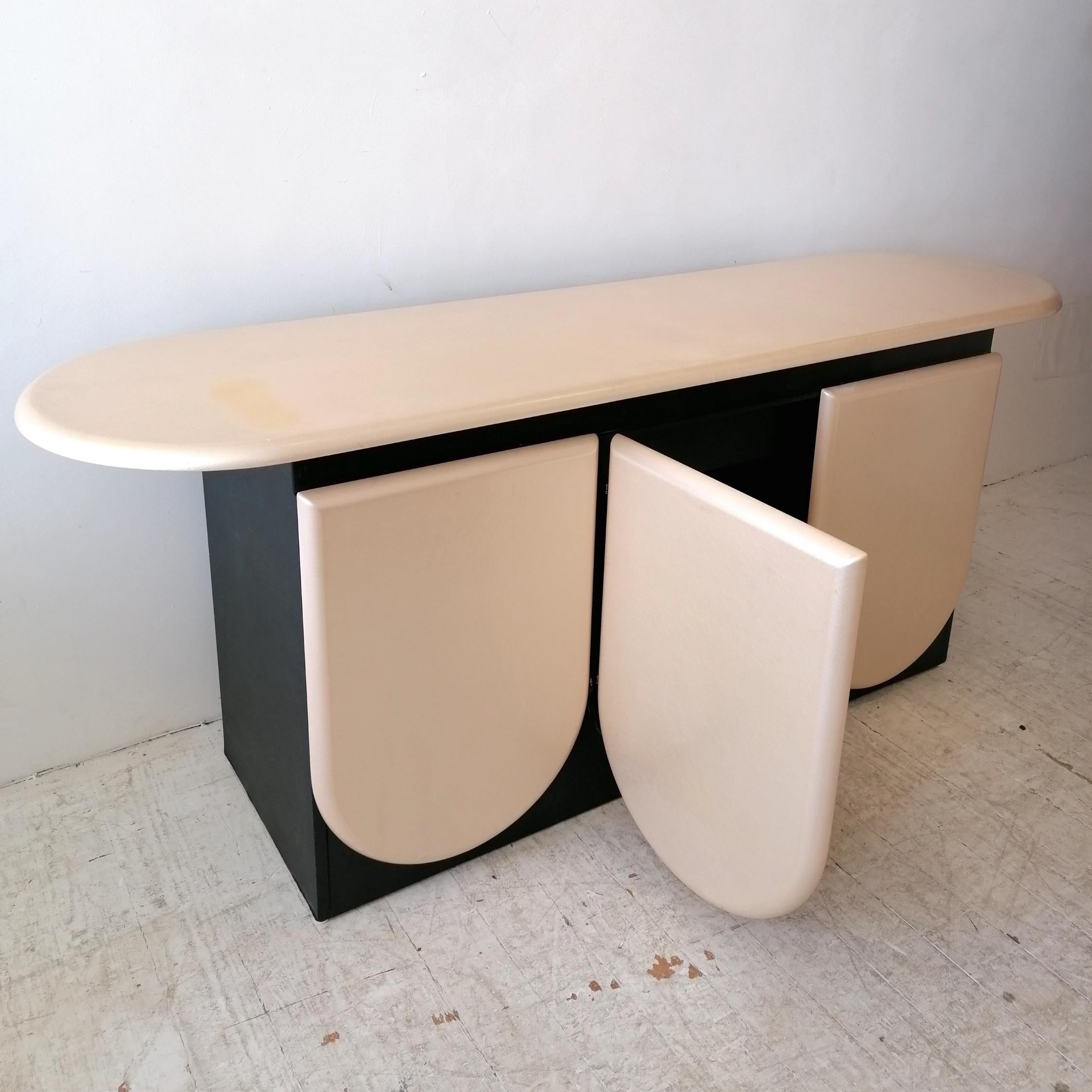A rare postmodern pearl & black sideboard with petal-shaped doors, by Roger Rougier, Canada 1980s .
I can't find another anywhere online. The top and doors are a pearl lacquer...difficult to show the pearlescent sheen in photos. The body of the