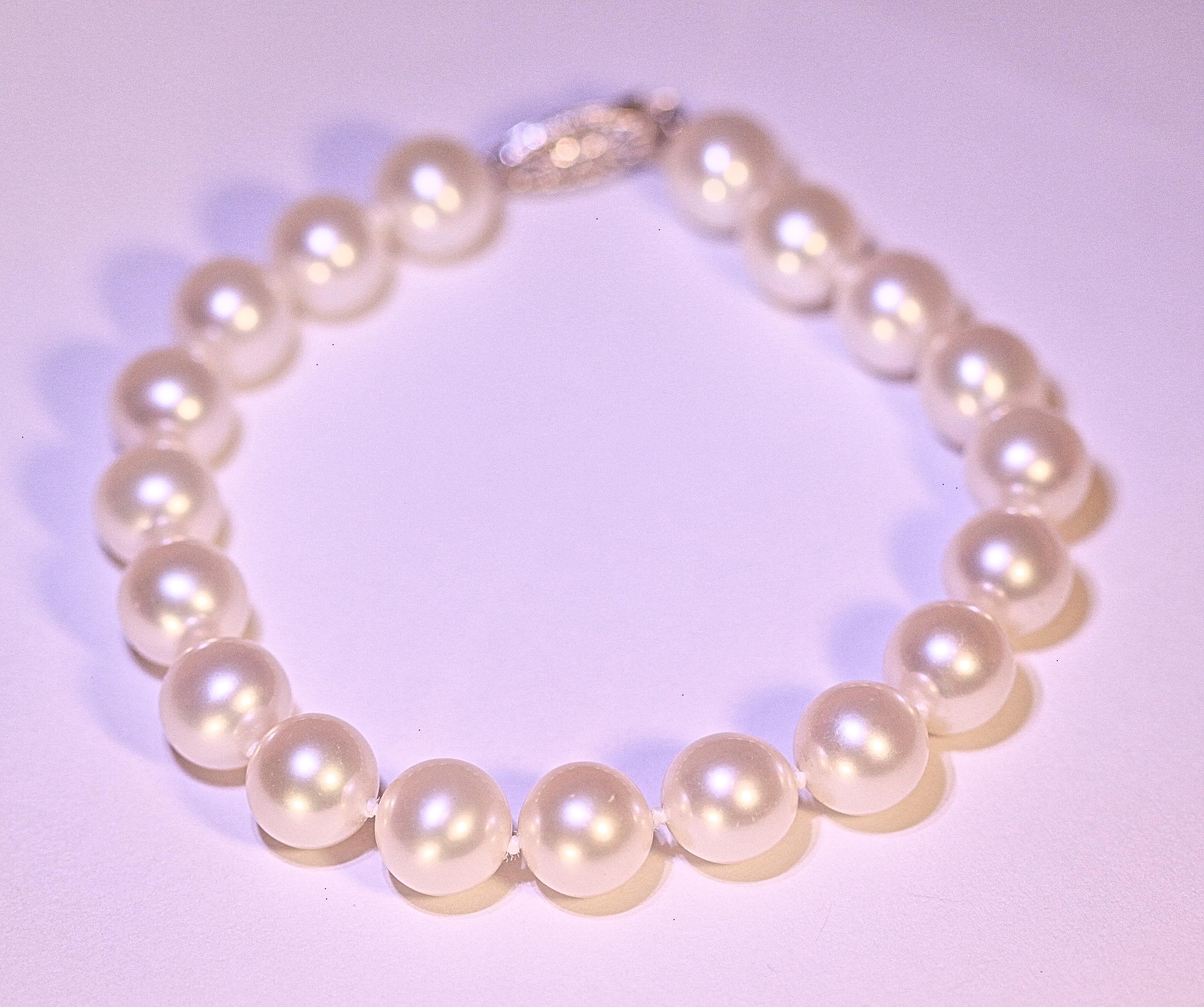 A pearl bracelet that measures eight inches long with 19 South Sea pearls.   The pearls measure 9 mm, they are cream white in color with nice luster and minor blemishes.  The bracelet has a 14 karat white gold clasp.