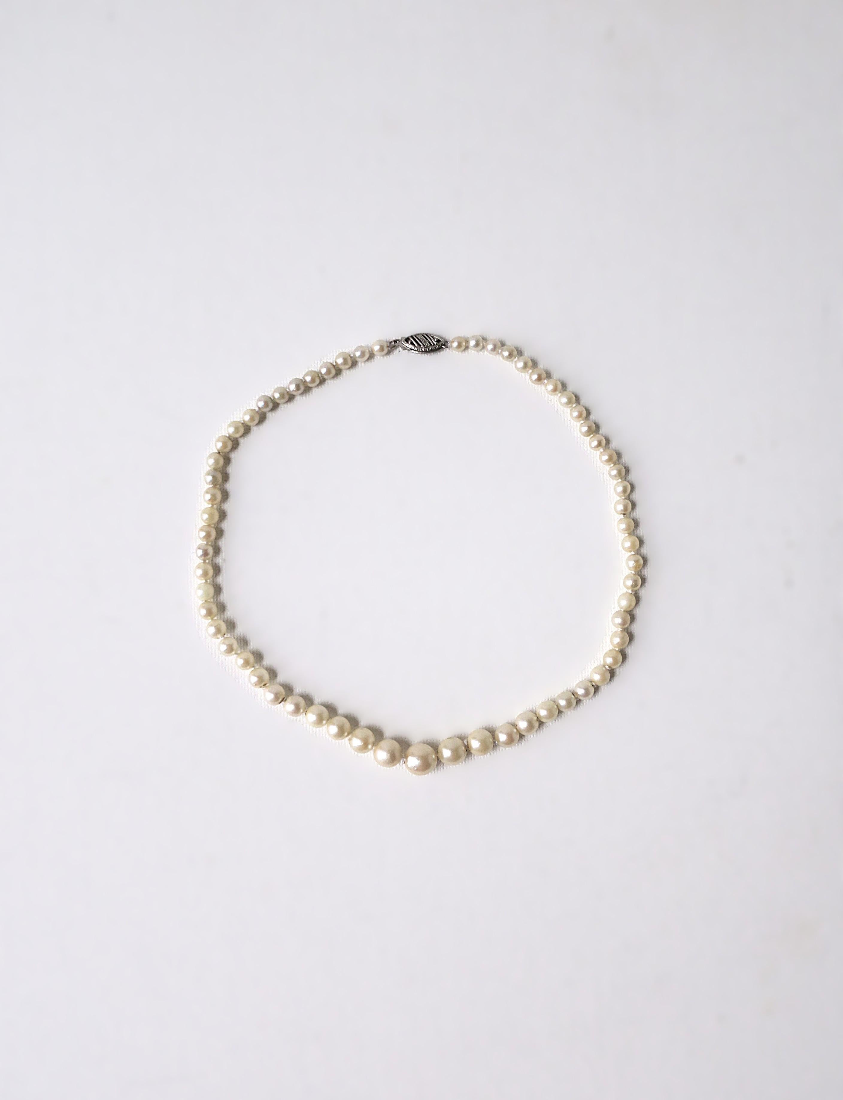 Collana a girocollo di perle coltivate bianche con chiusura in oro bianco 14 carati, circa metà del XX secolo. Una bellissima collana composta da perle coltivate bianche graduate, rifinita con una chiusura in oro bianco a 14 carati. Indossala da