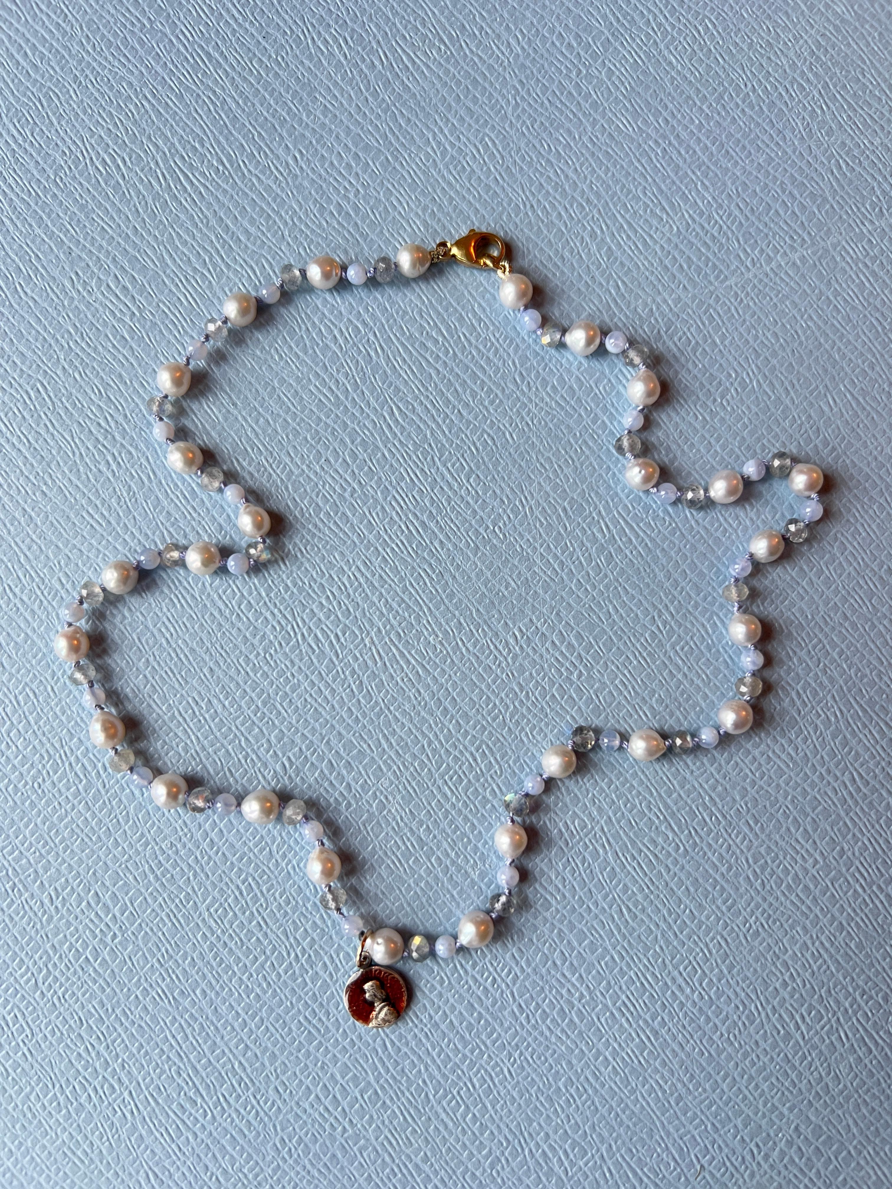 Pearl Choker Necklace Medal Light Blue Labradorite
Multi Bead Necklace with a Joan of Arc mini medal and a Gold Filled Clasp

White pearls are known for their calming effects, offering peace to those who wear them. They promote purity, integrity,