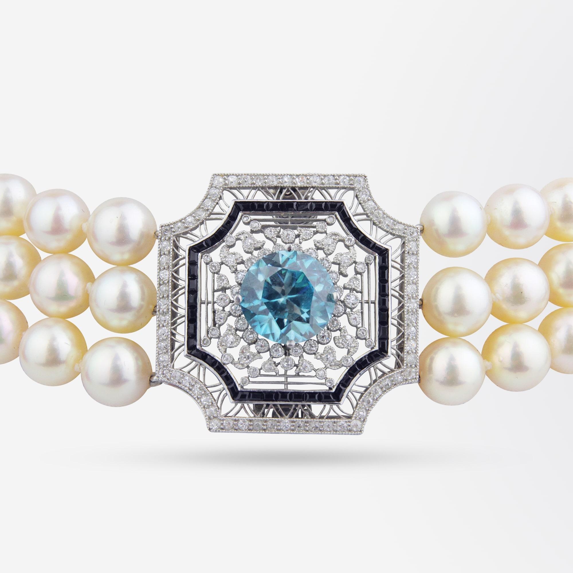 An incredible example of Belle Epoque jewellery in the form of a pearl choker featuring a circa 1915 Platinum, Diamond, Onyx and Blue Zircon detachable panel. Likely to have originally been a brooch pendant, the panel has been incorporated into a