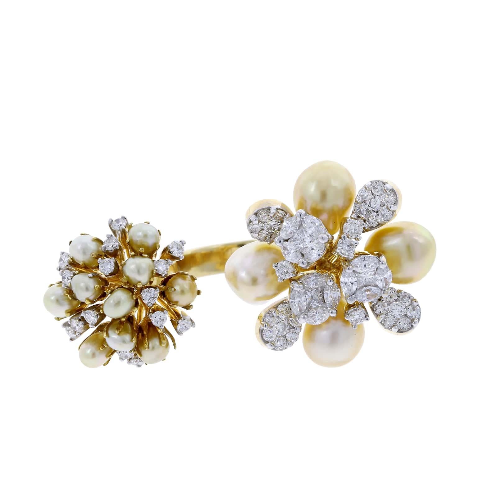 A stylish and decorative open ring with two clusters of pearls, accented with mixed cut diamonds. Princess Diamonds (0.34 cts), Marquise Diamonds (0.81 cts), Round Diamonds (1.44 cts), and Pearls (17.50 cts). 18K Gold.