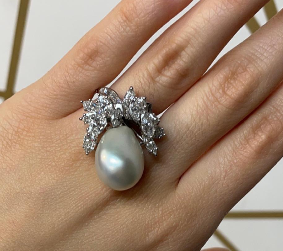 Pearl Cocktail Ring 

A cultured pearl ring accented with marquise and baguette-cut diamonds, featuring a hinged band. 

Ring Size: 5.25 
Resizable free of charge
Metal Type: Platinum
