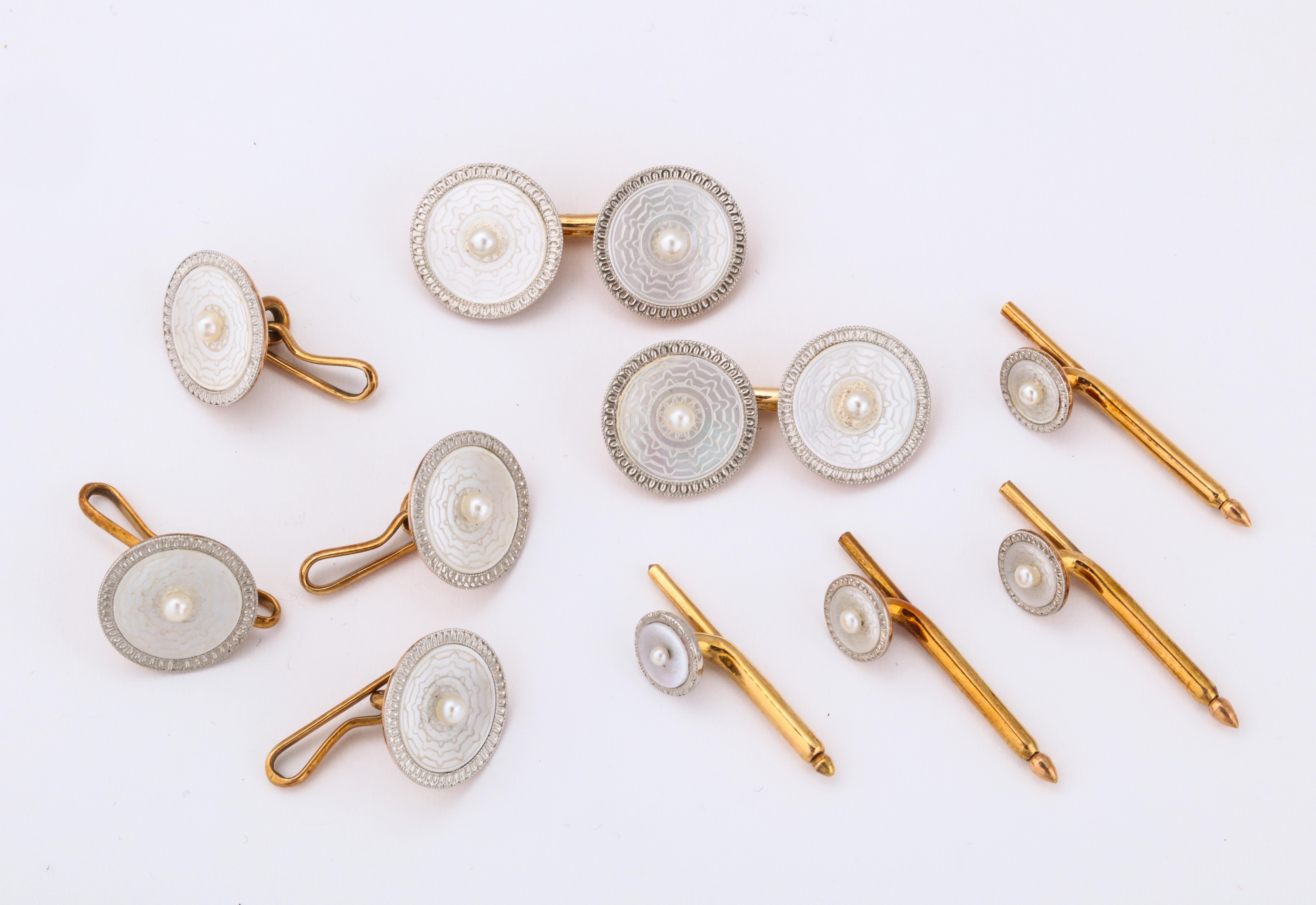 Mother of pearl, seed pearl, diamond cuff link set.

Set in gold and platinum

Made circa 1920