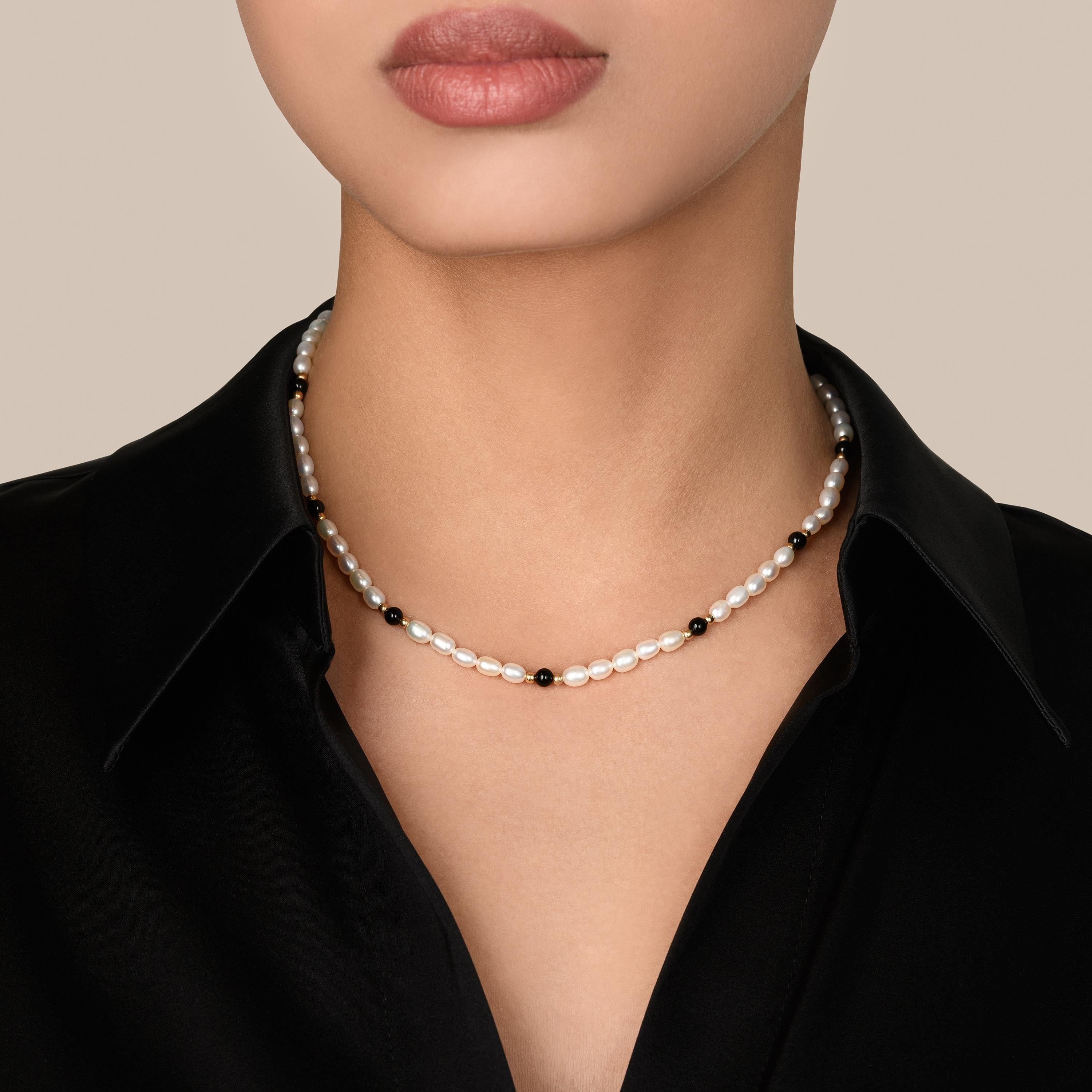 Experience the captivating allure of our Pearl Delight with Onyx. The Pearl, Onyx, and 18k Gold Plated Stainless Steel Beads Necklace. This exquisite piece harmoniously combines the timeless elegance of pearls with the sleek sophistication of onyx.