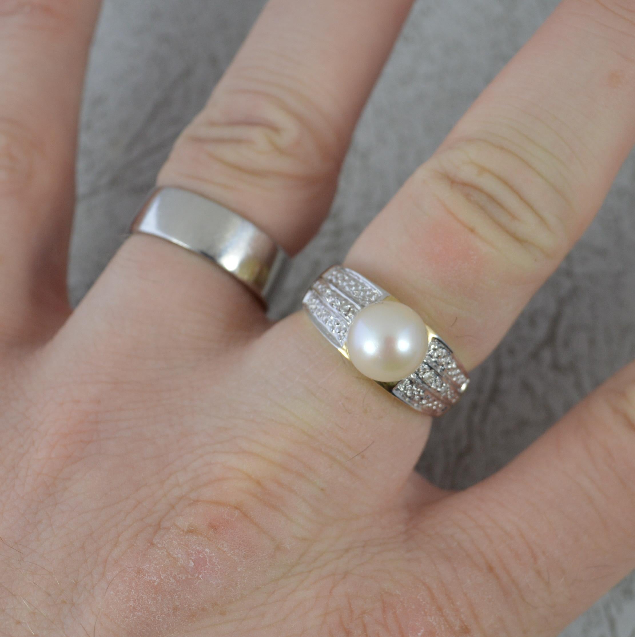 A superb Pearl and Diamond ring.
Solid 14 carat yellow gold example with white gold setting to the sides.
Designed with an 8mm diameter pearl to centre and a small diamond to each side.

Condition ; Very good. Clean band. Well set stones. Issue