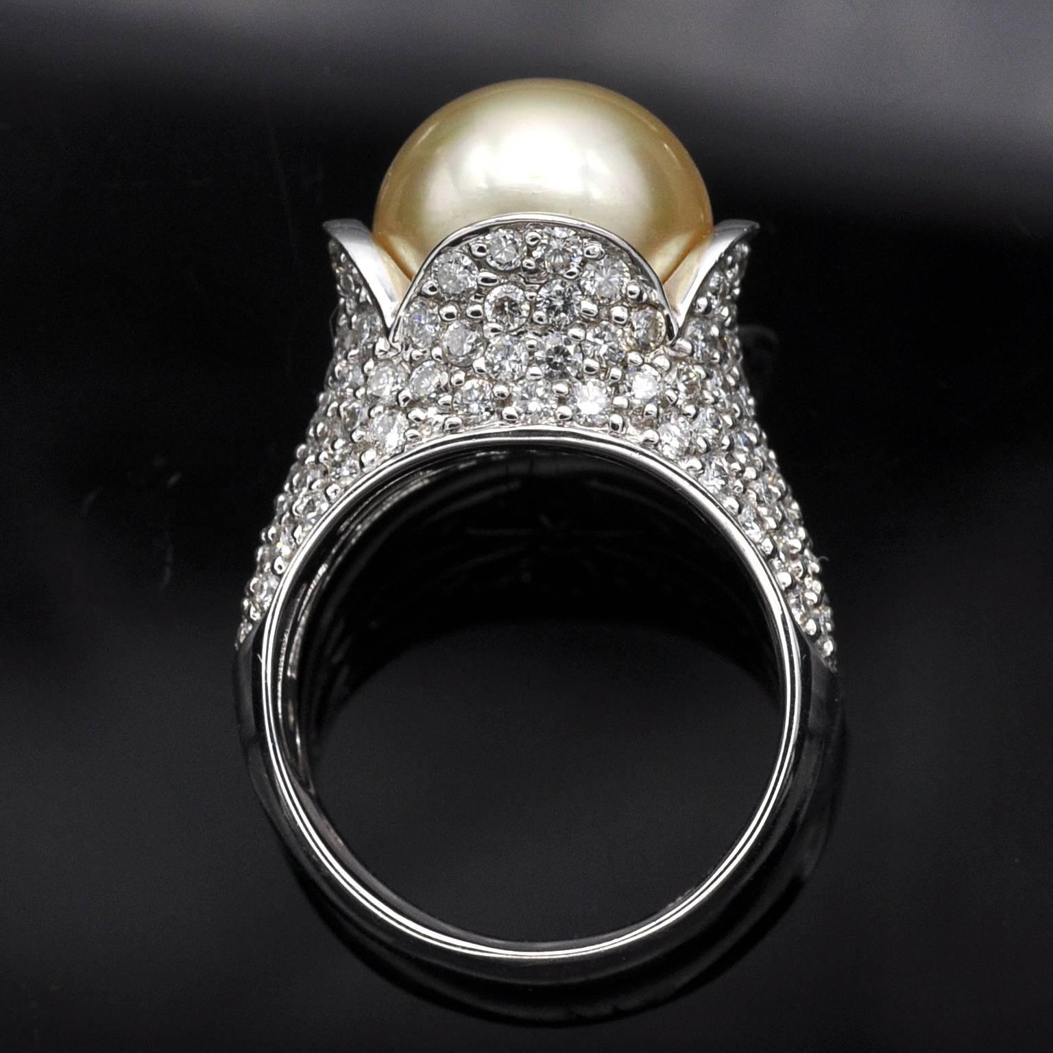 A golden pearl nested in a flower like 18 Karat gold cocktail ring pavé set with white diamond .
The design is timeless and fashionable. 
White diamonds: 2.35 carat
18KT gold , French Hallmark stamp
Pearl: 12mm