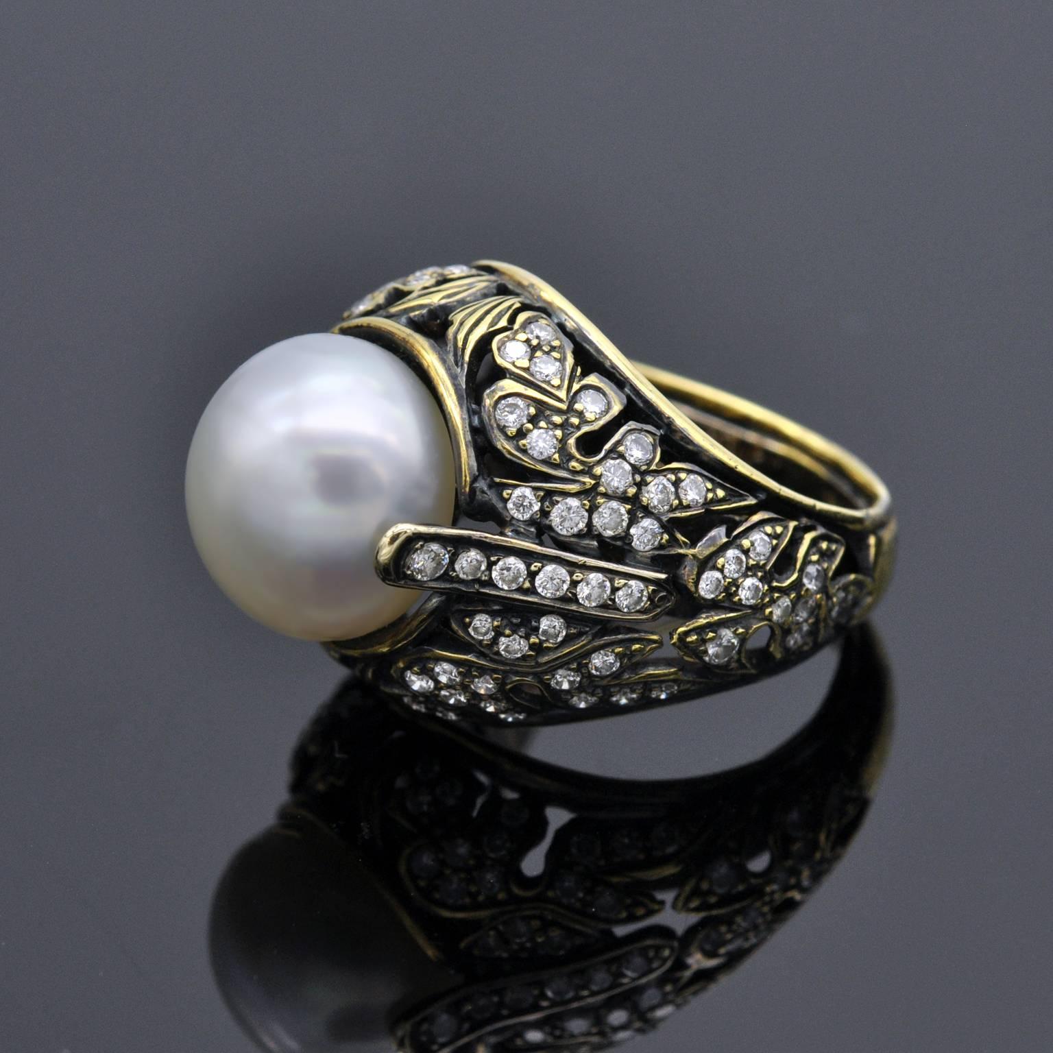 One of a kind pearl ring by Claris A. completely handmade. An intricate design of leaves has been cut out of the 18 KT  blackened yellow gold main ring body. Engravings and diamonds complete its delicate lace-like aspect. The pearl is 11.9 mm in