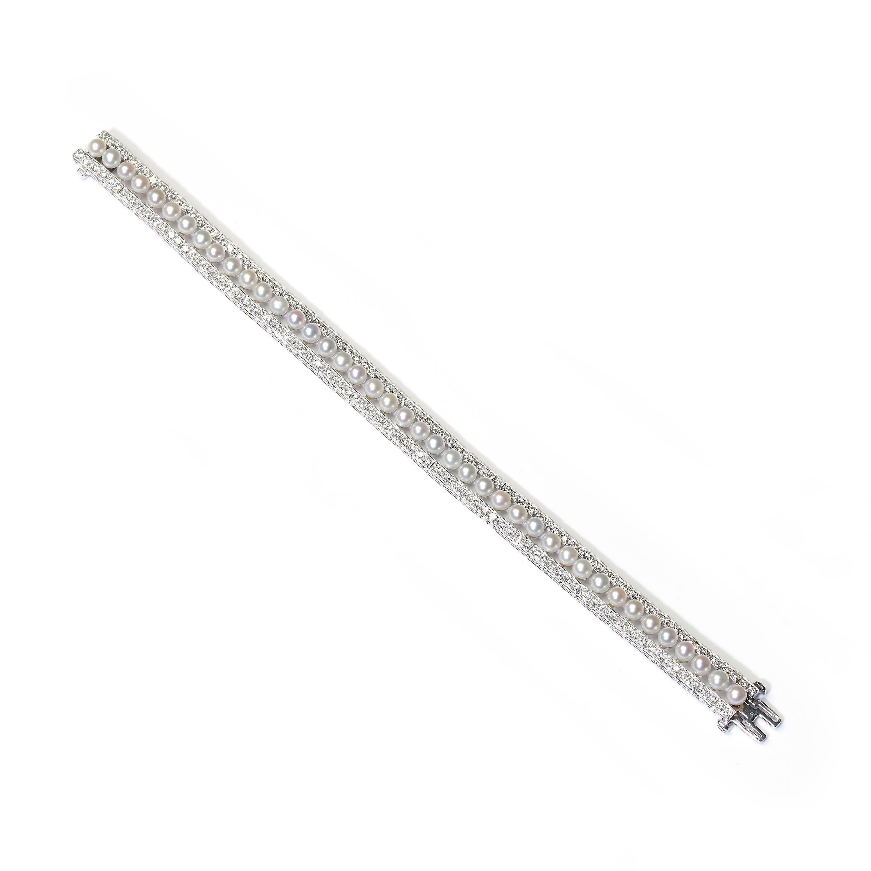 A modern pearl, diamond and platinum line bracelet, featuring a row of forty-one, cultured pearls, with round brilliant-cut diamonds, with a total weight of 3.81ct, in paired grain settings, forming a row either side of the pearls, with millegrain