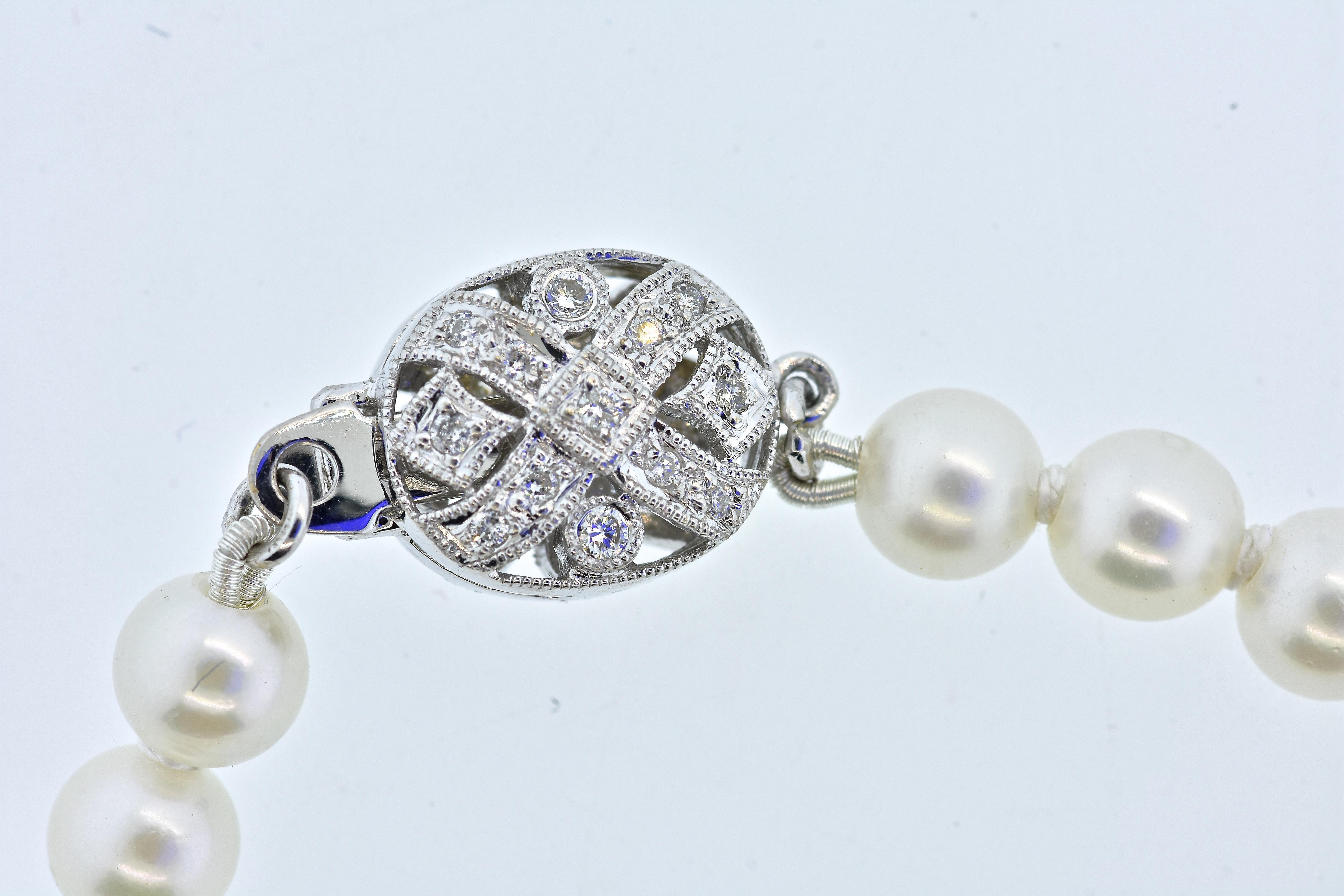 Diamond and white gold clasp which has diamonds on both sides of the clasp - so one never cares if it happens to turn as you move.  The pearls are very fine - white, smooth surfaces, and round, they are all luminous and reflect the light well