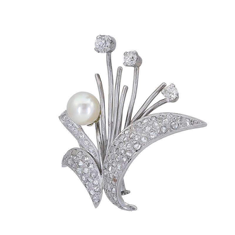 This Pearl and Diamond spray brooch is a classic! 

This lovely Estate piece features an 8mm cultured pearl which is accented with a spray of 3 old miner diamonds weighing approximately a carat.

The pin measures 1 ¾ x ¾ x 1 ½ inches and is set in