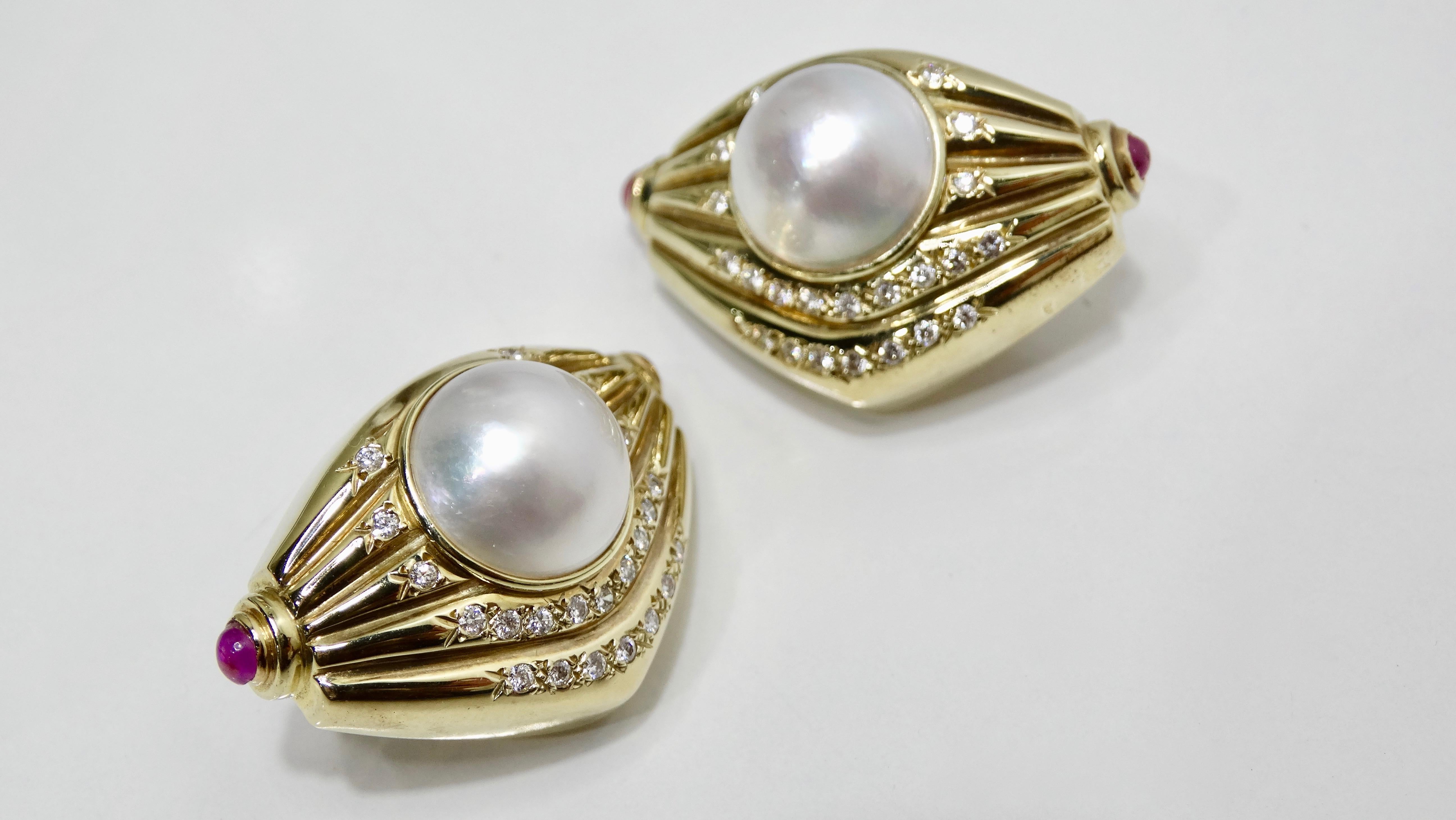 Complete your look with these stunning earrings! Circa 1970s, these ribbed geometric shaped earrings are 14k Gold and set with a large natural Pearl. Features Cabochon cut Pink Sapphires are on both ends, five rows of round brilliant cut Pave set