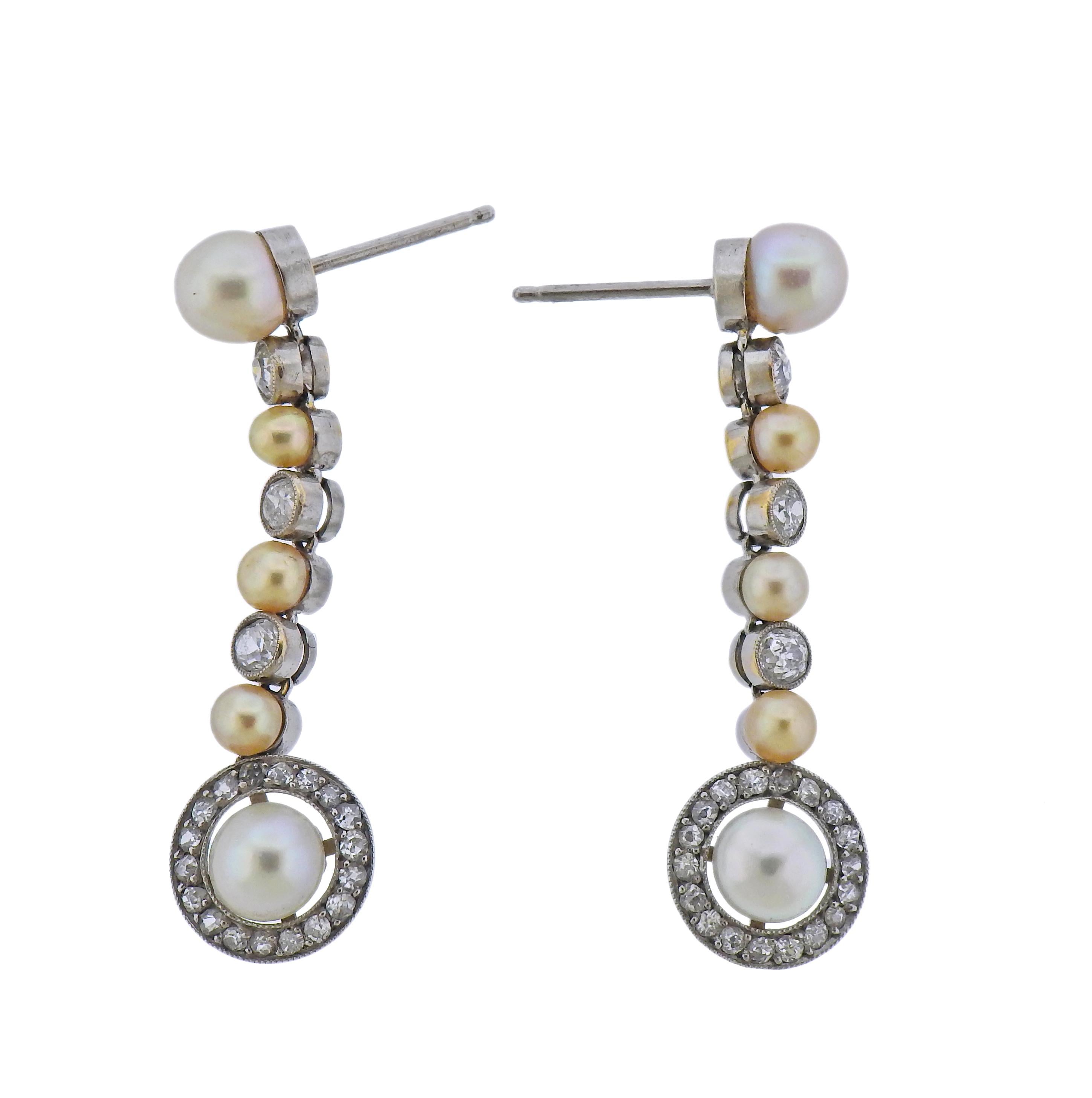 Pair of 18k gold long drop earrings, with 0.80ctw in diamonds and 10.2mm pearls. Earrings are 45mm long. Marked 750. Weight - 11.6 grams.
