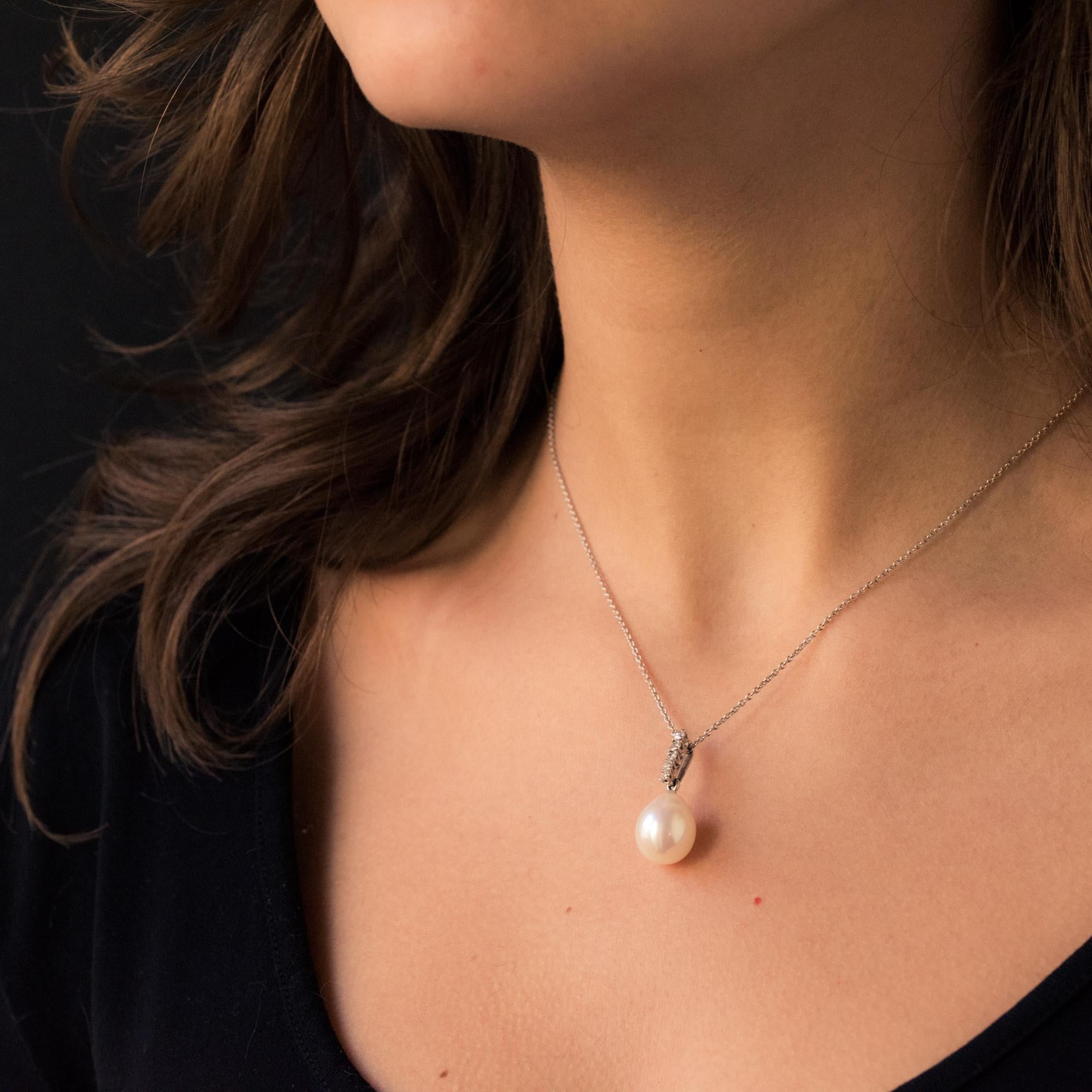 Pendant and chain in 18 carat white gold, eagle head hallmark. 
Featuring an oriental cultured white rose pear shaped pearl, suspended from a column of 5 claw set brilliant cut diamonds.  
The round style chain enhances this pendant beautifully.