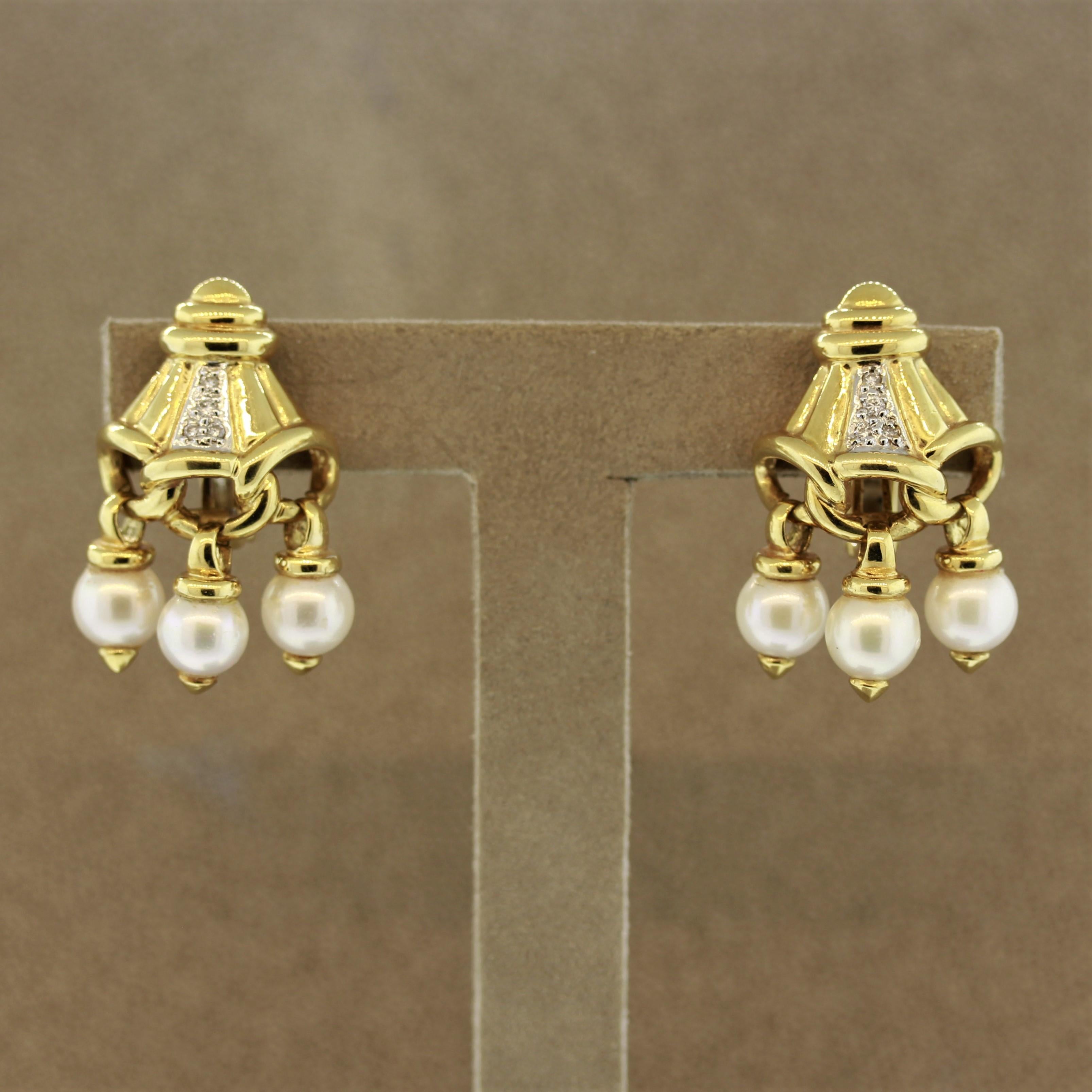 A unique pair of earrings made in 18k yellow gold. They feature 0.10 carats of round brilliant cut diamonds along with 6 freshwater pearls which are tasseled from the bottom of the earrings.

Length: 1.2 inches