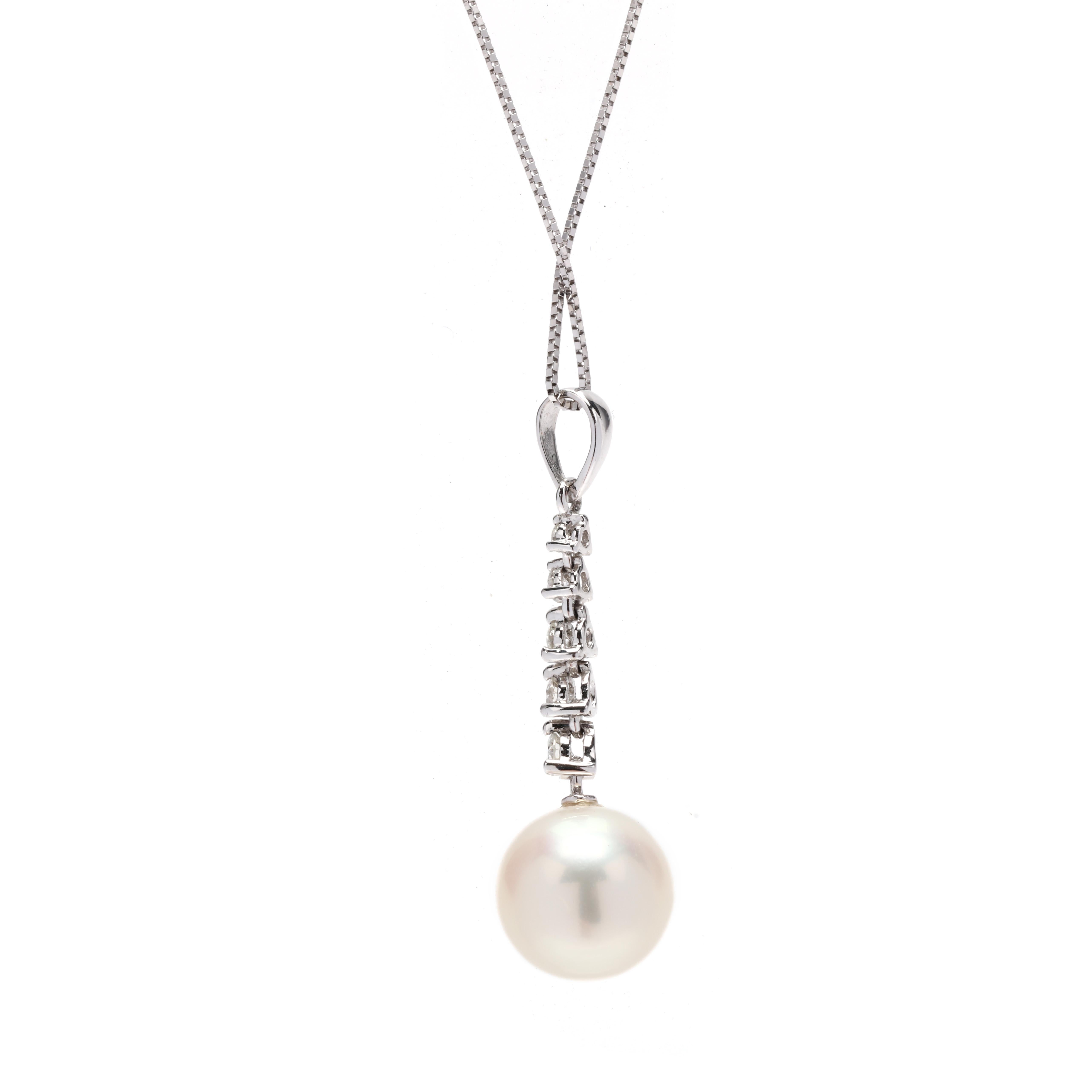 A 14 karat white gold pearl and diamond pendant necklace. This everyday pearl necklace features a tapered design of prong set, round brilliant cut diamonds weighing approximately .14 total carats with a 9.5 mm white pearl below, and all suspended