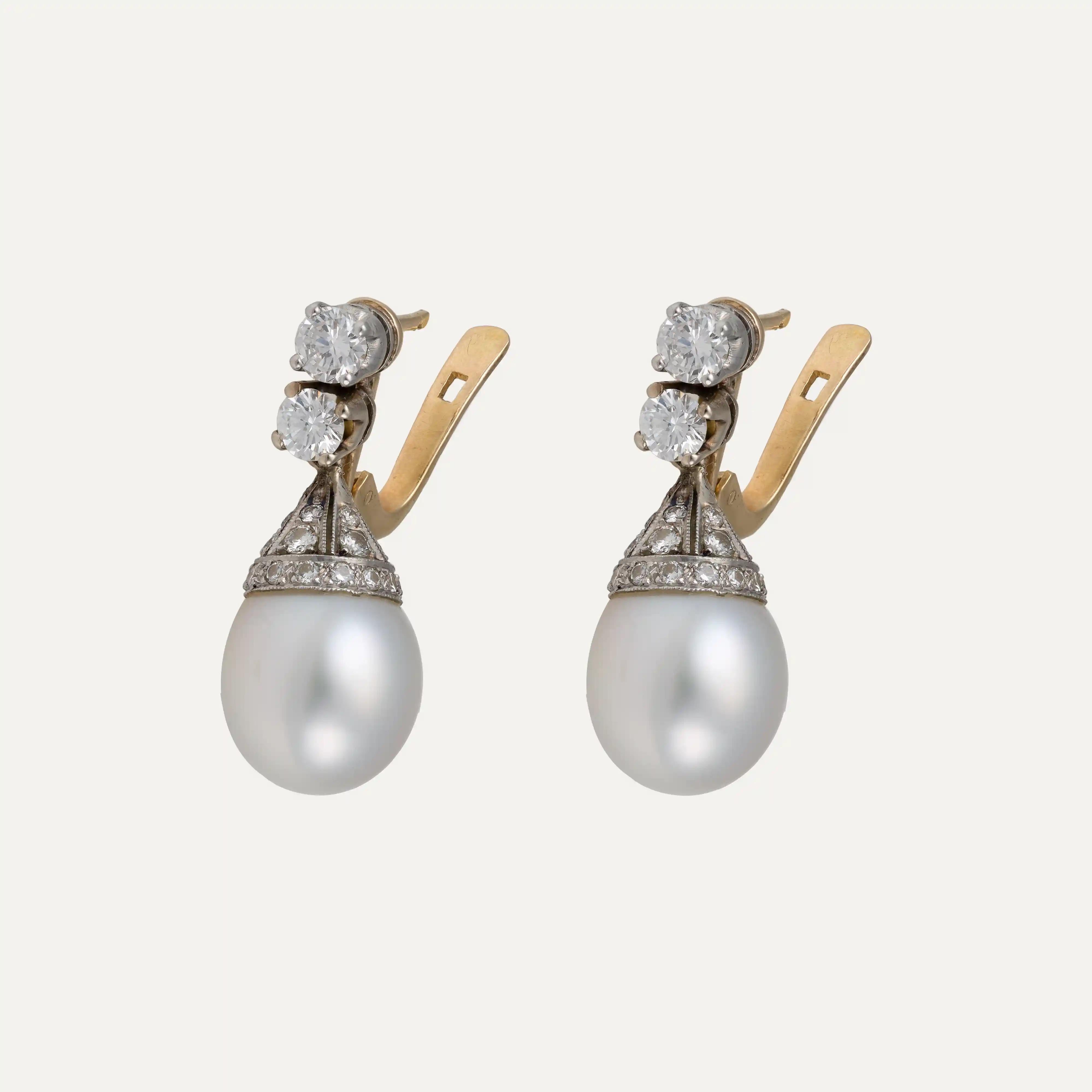 Elevating timeless elegance, these Pearl, Diamond, Platinum, and Gold Drop Earrings are a refined tribute to classic jewelry craftsmanship. They feature a harmonious combination of platinum and yellow gold, offering both sophistication and