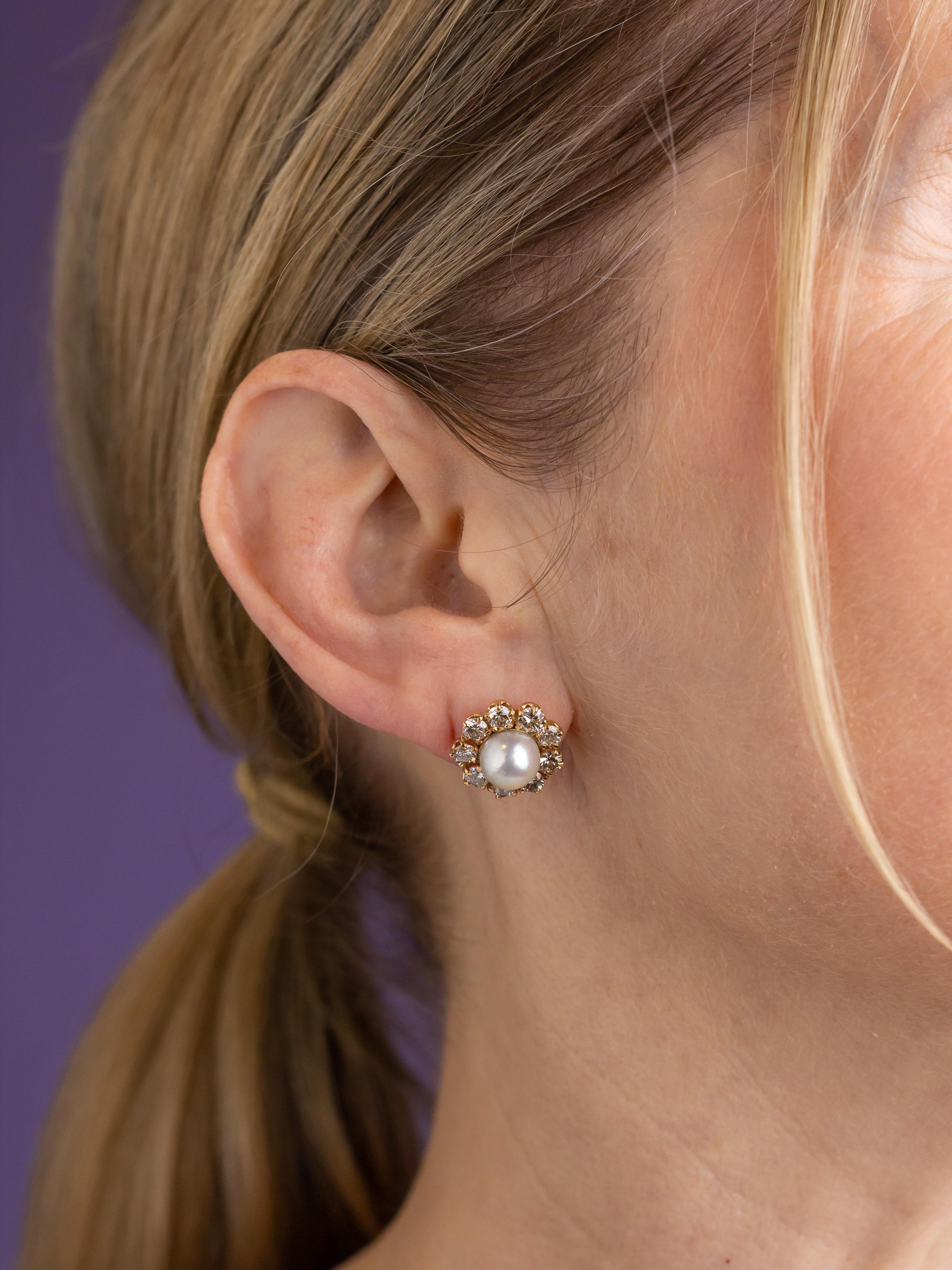 This delicate pair of stud earrings are in the form of a posy and are set with Akoya pearls and diamonds. The frames of the studs are crafted from 14 karat yellow gold and centre on a natural cultured Akoya pearl measuring 8.28 millimetres each.