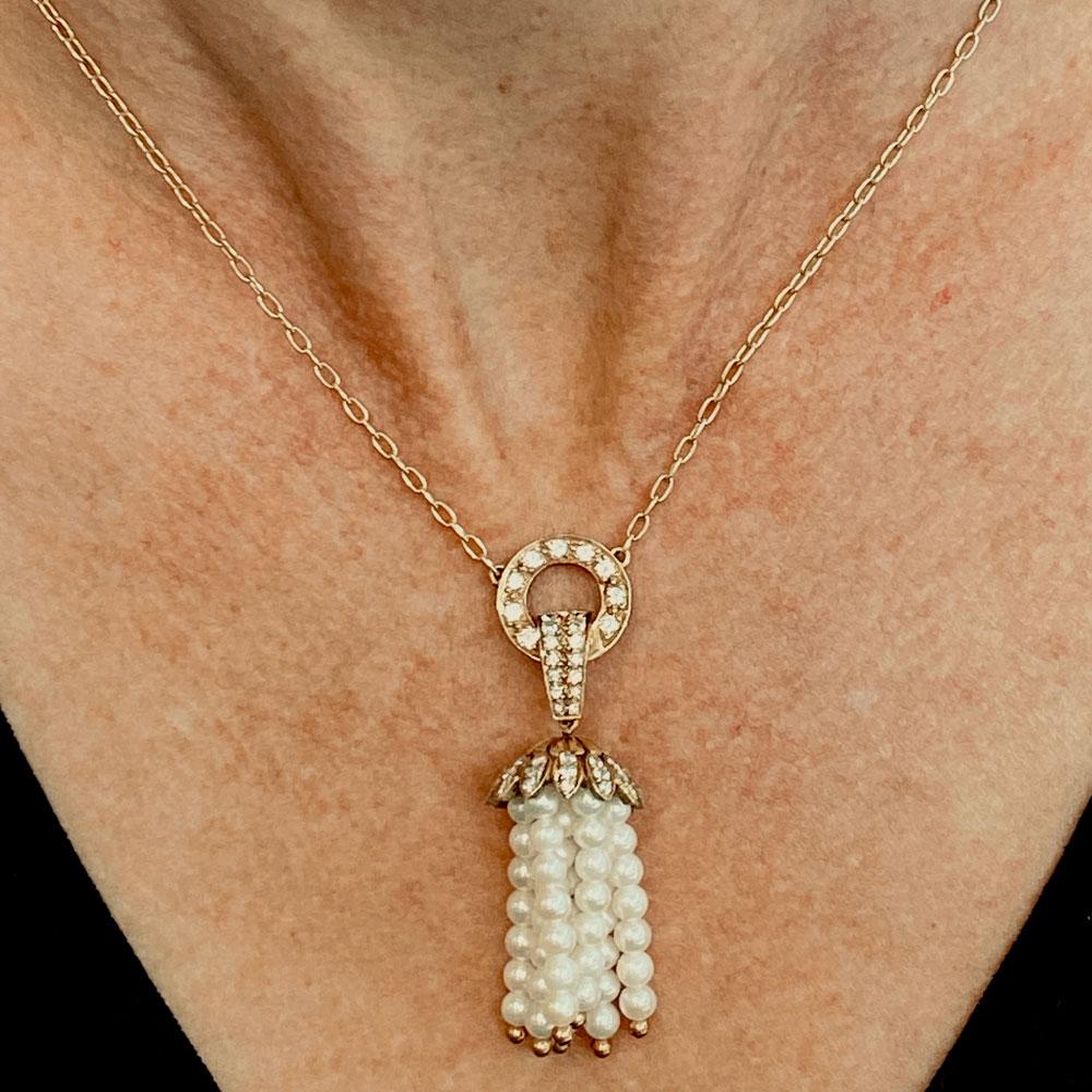 Fabulous pearl and diamond tassel pendant necklace is fashioned in 18 karat yellow gold. The pendant features 60 round brilliant cut diamonds weighing 1.05 CTW. The diamonds are F-G color and VS clarity. The drop measures 2.00 inches in length and