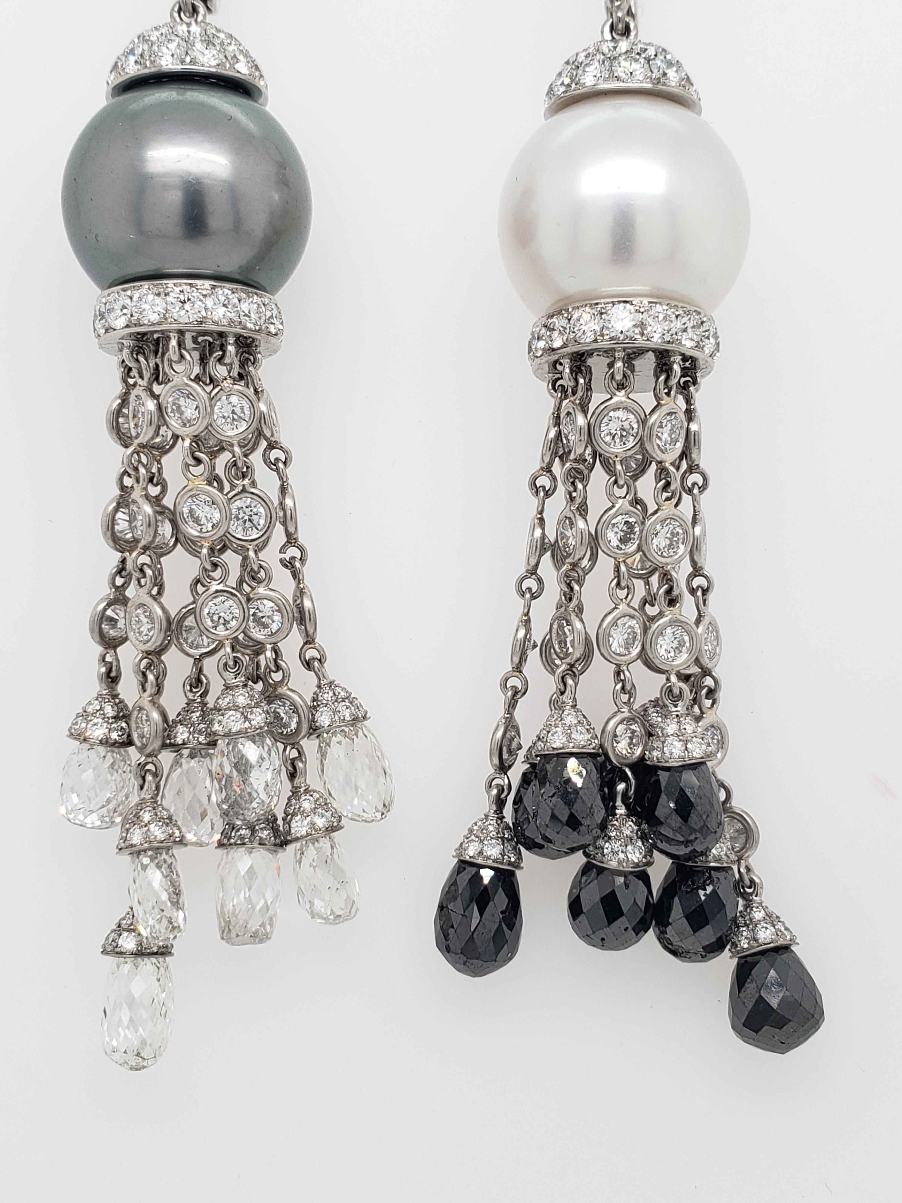 These South Sea Pearl and Diamond Earrings are breathtakingly elegant! 

They contain one White and one Dark Gray Tahitian South Sea 14mm Pearl mounted with sixteen Black and White Briolette cut diamonds totaling 18.51 carats and white pave diamonds