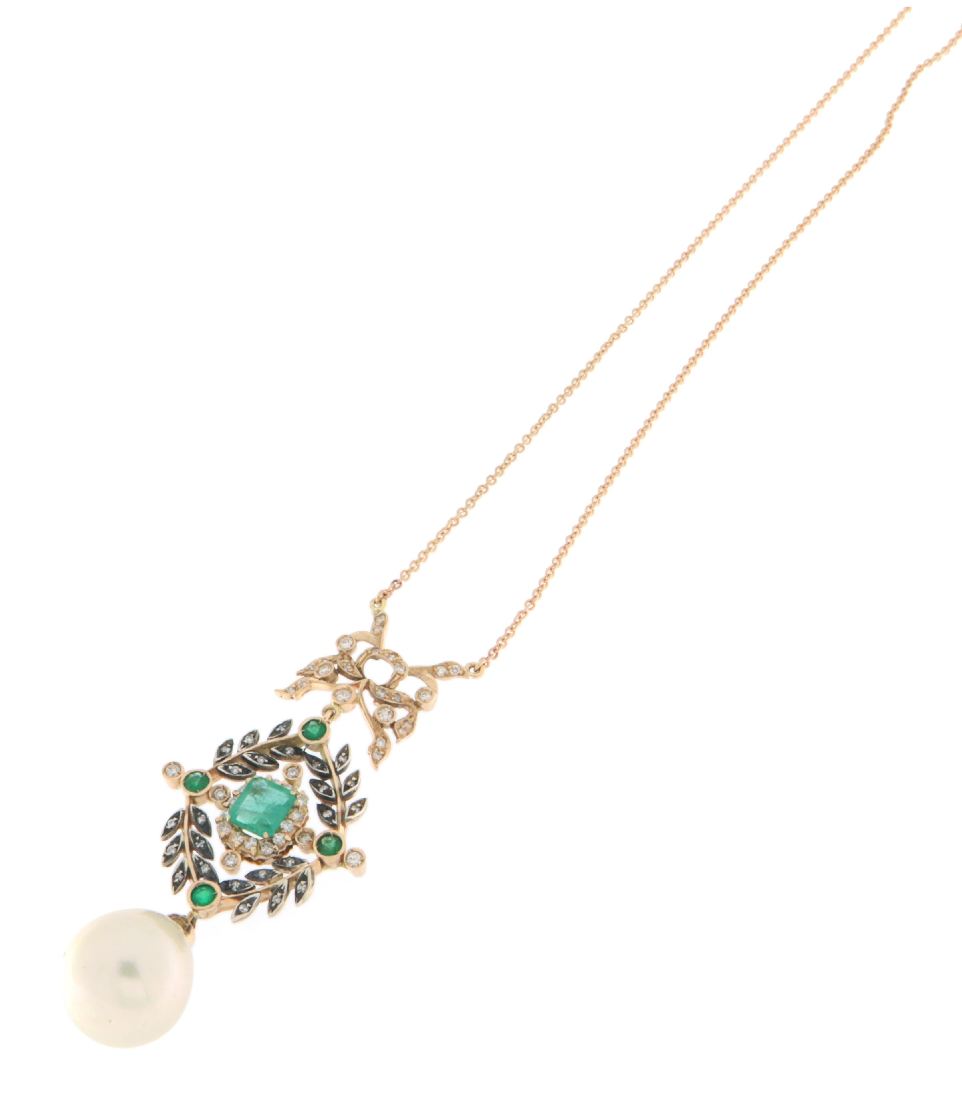 Stunning handcrafted pendant made from 14-karat yellow gold and 800 silver, a combination of materials that gives the piece a refined two-tone effect. At the heart of the design is a natural rectangular-cut emerald, showcasing an intense green hue