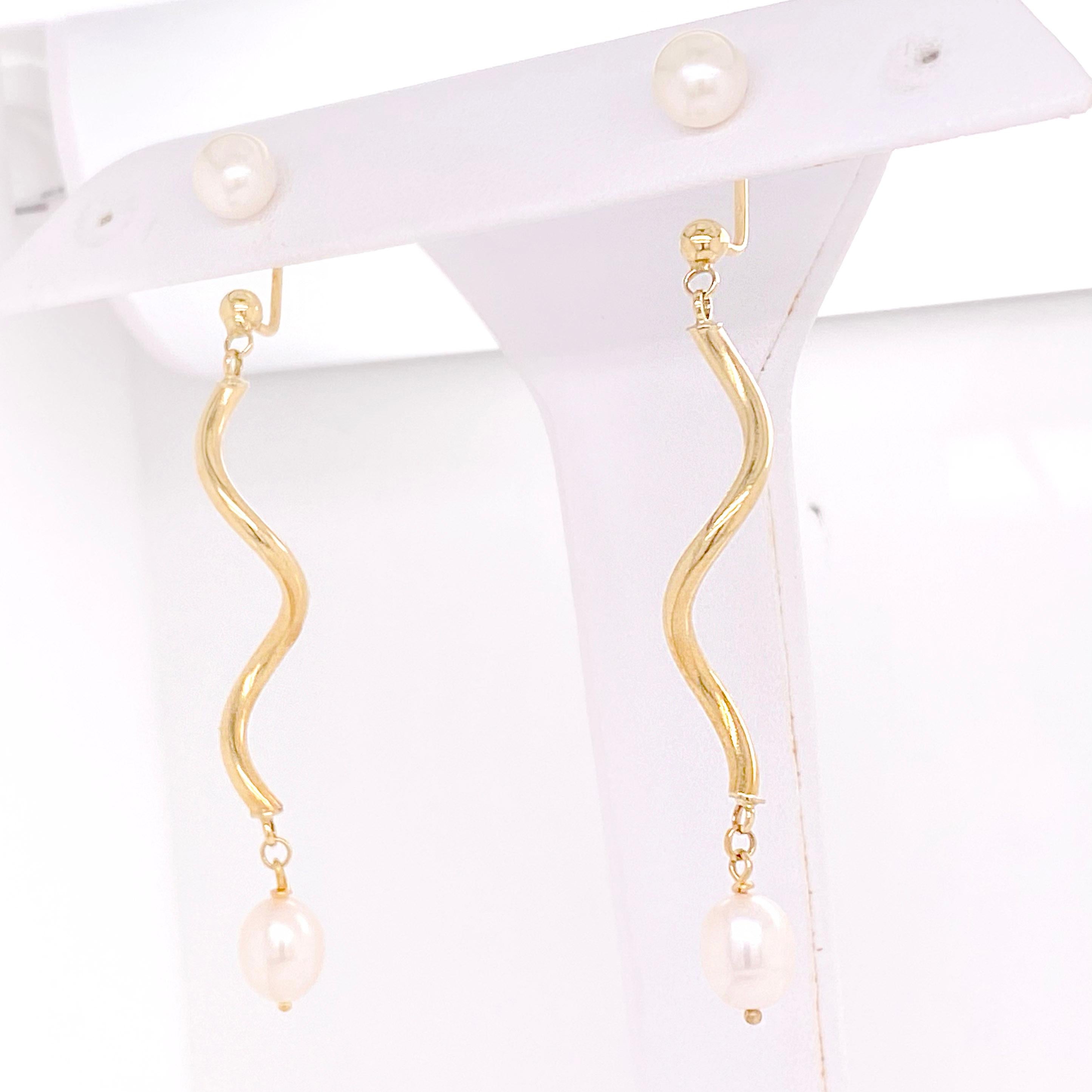 These long dangle earrings have a 7 millimeter pearl stud that has a swirly dangle of gold that is high-polished. There is a lovely white pearl at the bottom that swings from the gold. These The details for these gorgeous earrings are listed