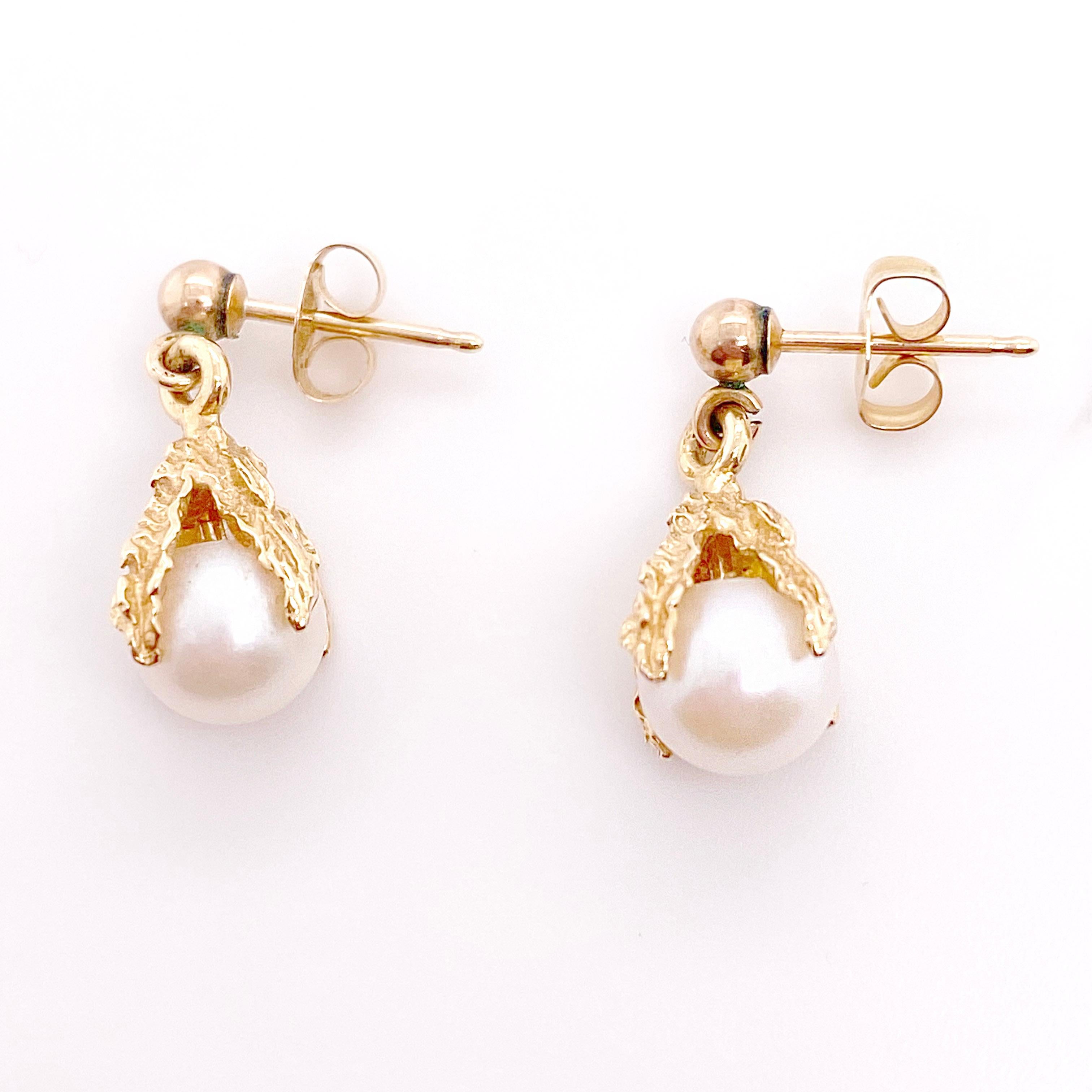 These drop pearl earrings are gorgeous with their talon design! The texture is gorgeous and this is well made yellow gold handcrafted design. The gold ball earring at the top is 14 karat yellow gold along with the earrings post and backs. The