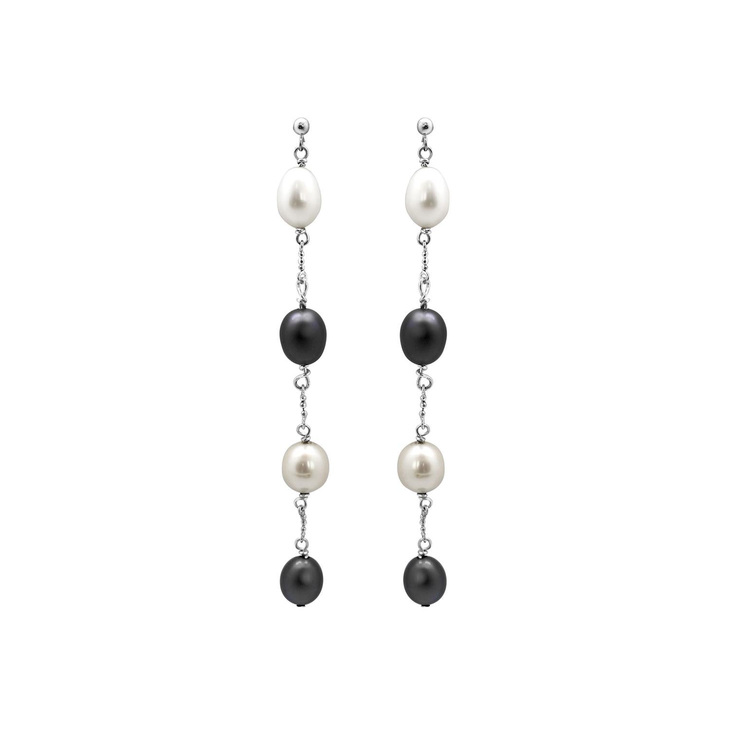 Timeless and alluring upcycled pearl drop earrings, both precious and sustainable. Floating on a  deliberately rough 18k recycled white gold chain, sleek freshwater pearls are retaining luminescence in their oval profiles. Handcrafted in London.