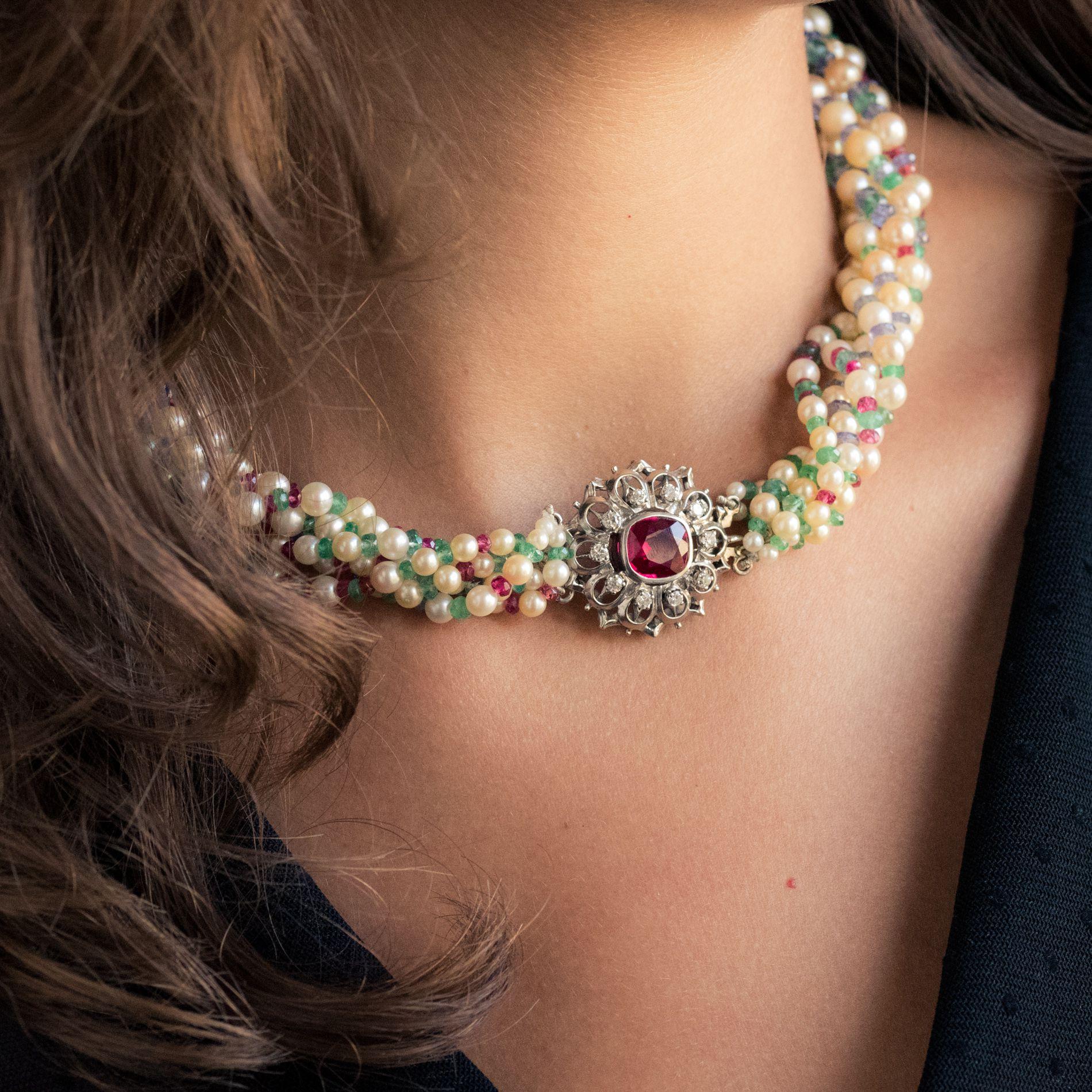 Baume creation - Unique piece.
Necklace of 6 rows of cultured white oriental pearls, diameters; 6.5/7 to 3/3.5, alternated with round and facetted oval emerald beads, pink facetted spinel beads, and facetted rubies and sapphires. The clasp is a 18