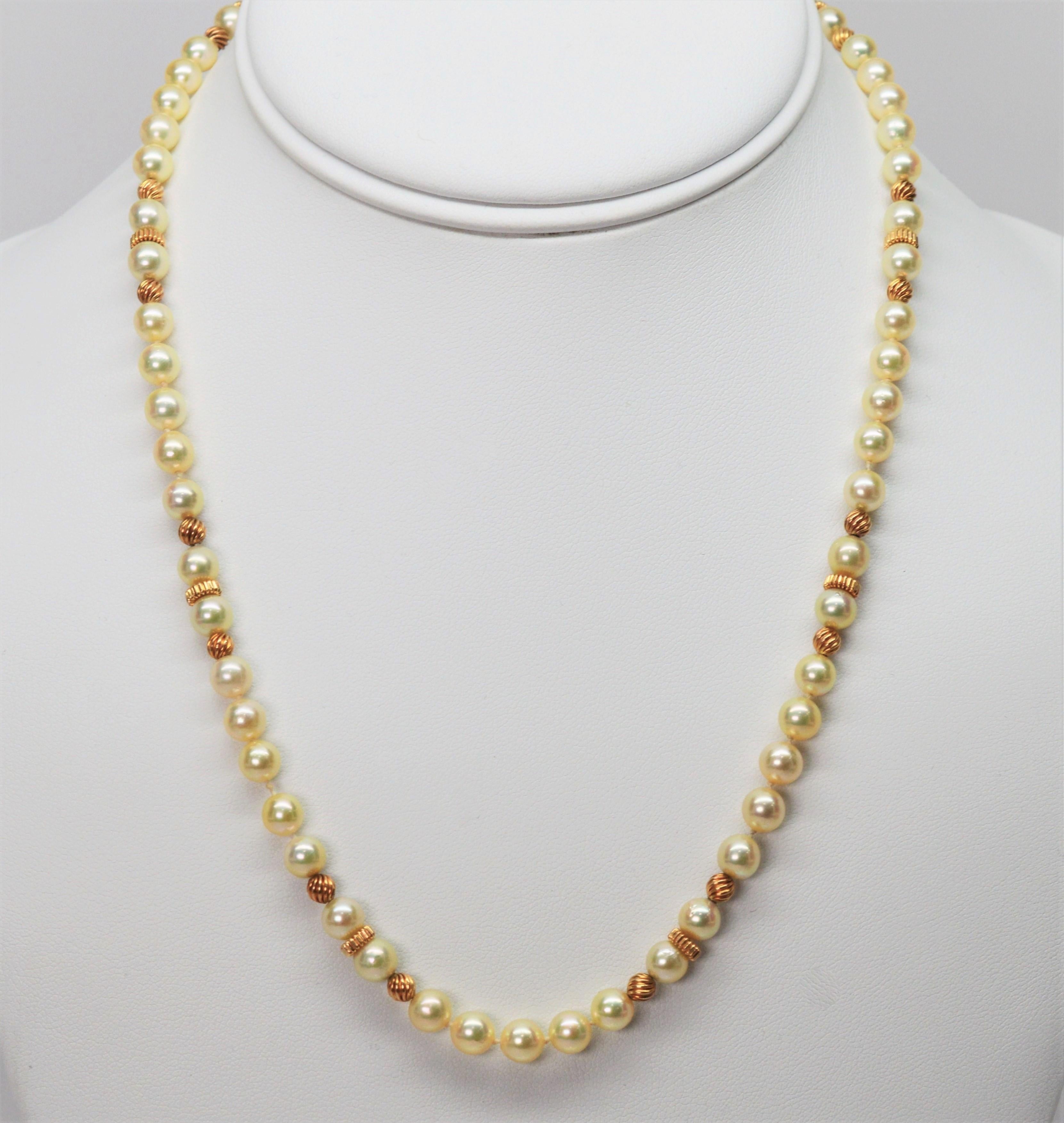 A lovely pairing of pearls and gold create matching strands for a beautiful duo. Crafted with 5.5 mm AAA round Akoya Pearls with a creamy golden hue and swirled fourteen karat 14K yellow gold rondelles. The necklace measures eighteen inches in
