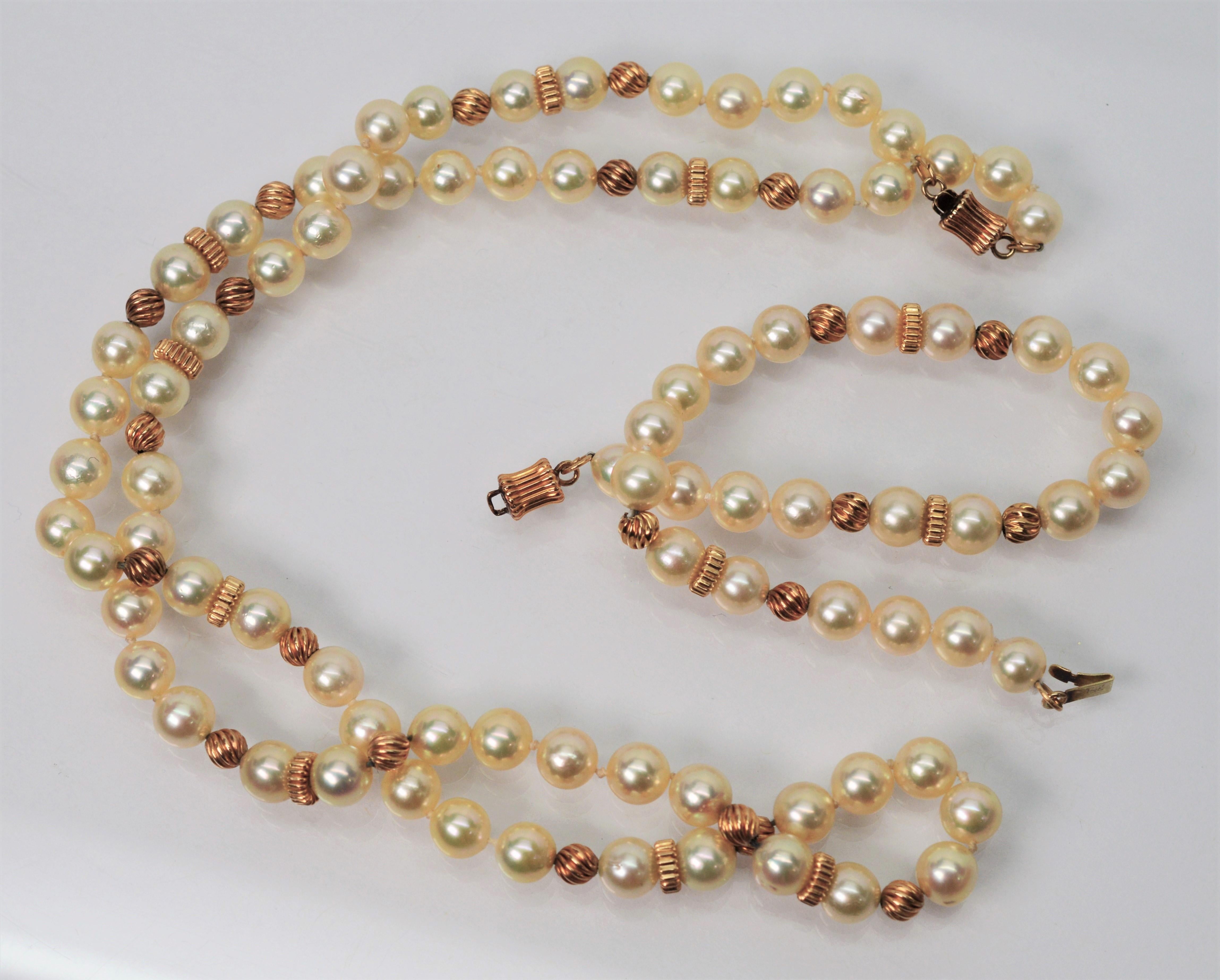 gold pendant set with pearl mala