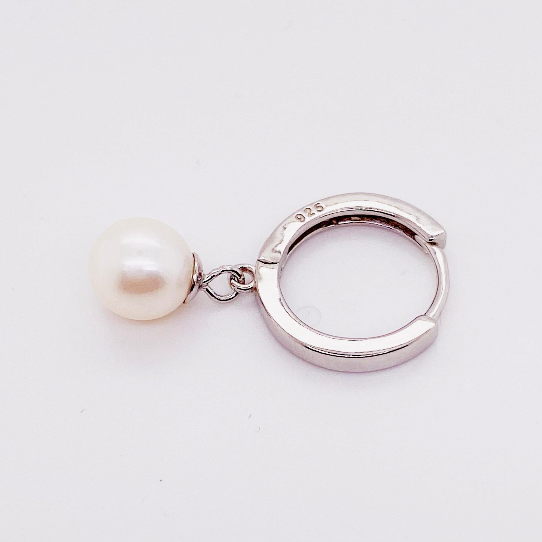 These fresh and fun earrings are  great for any woman! These are a quality design with the sterling silver handmade into lovely huggie earrings. There is a pearl with a cap on the top so that it swings while you are wearing them. These are an