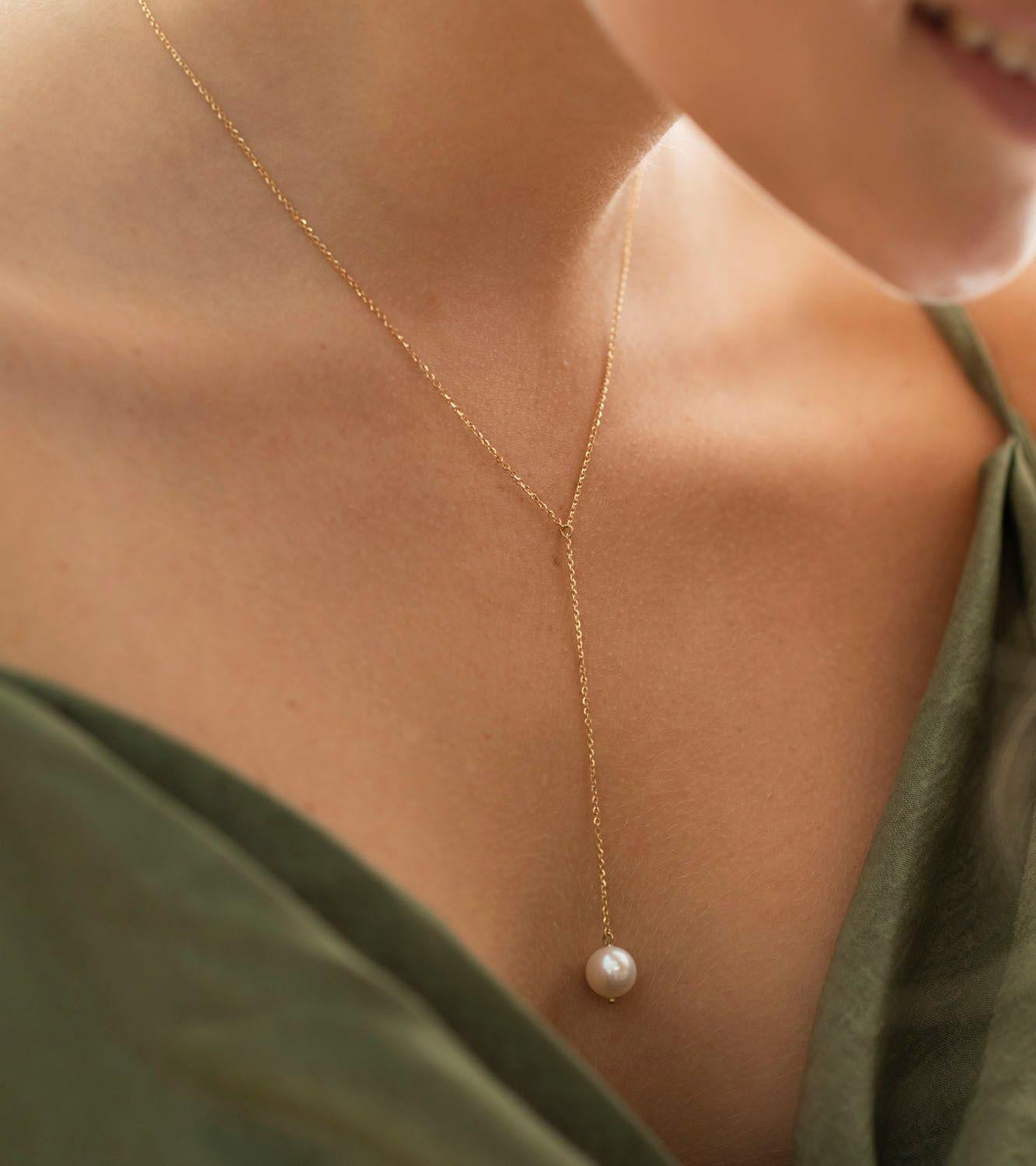 The Pearl Lariat necklace features a lustrous freshwater pearl, with size 9mm-10mm  suspended from a delicate and sparkly 18Karat Yellow gold chain.

The simplicity of its design, gives it a timeless appeal and offers a modern and fresh approach to