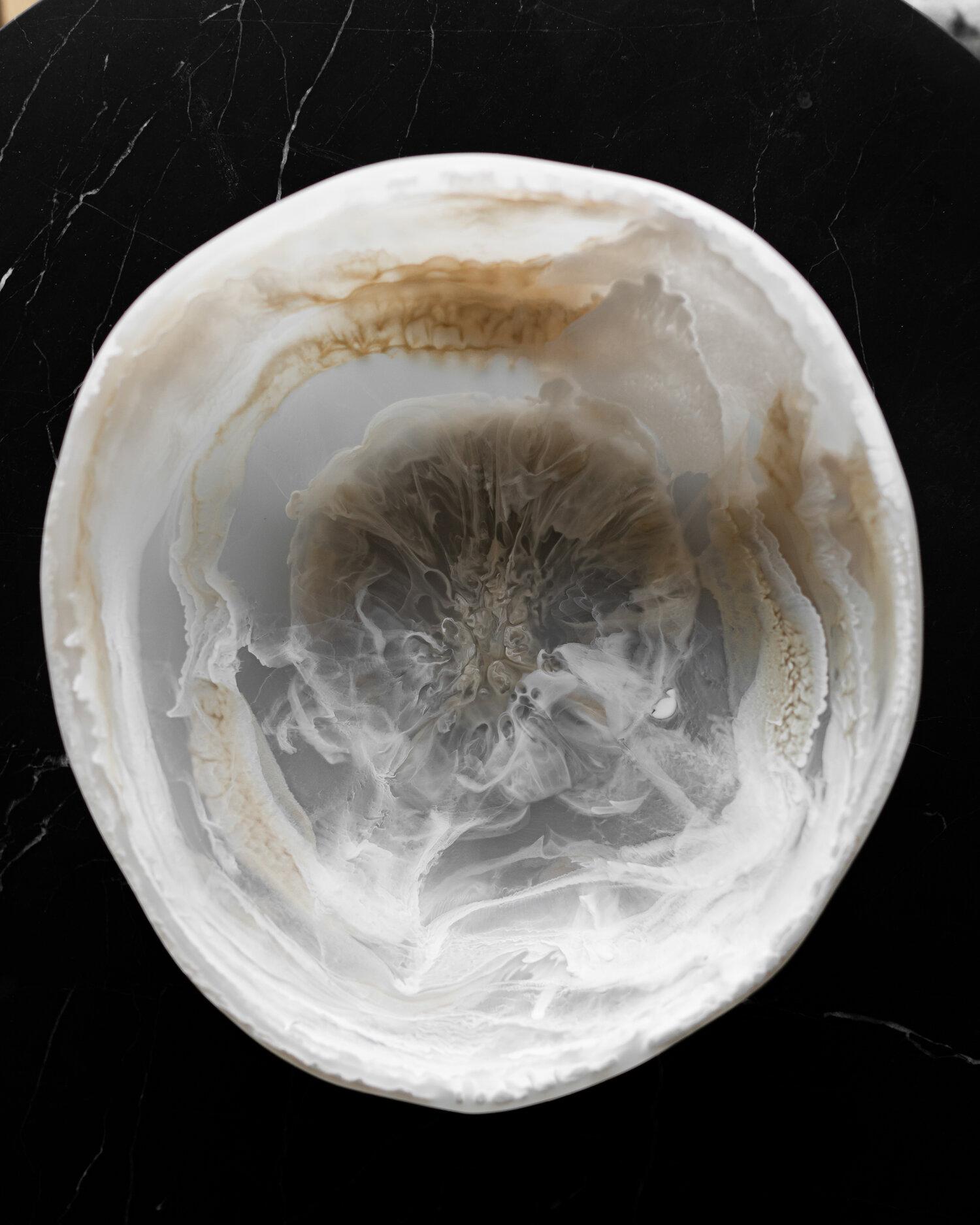 This pearl marble resin bowl's shape evokes that of natural stone, and is a beautiful example of the artisanal craftsmanship that goes into each piece designed by Monica Calderon and handmade by expert artisans in Mexico. The stone resin bowl in
