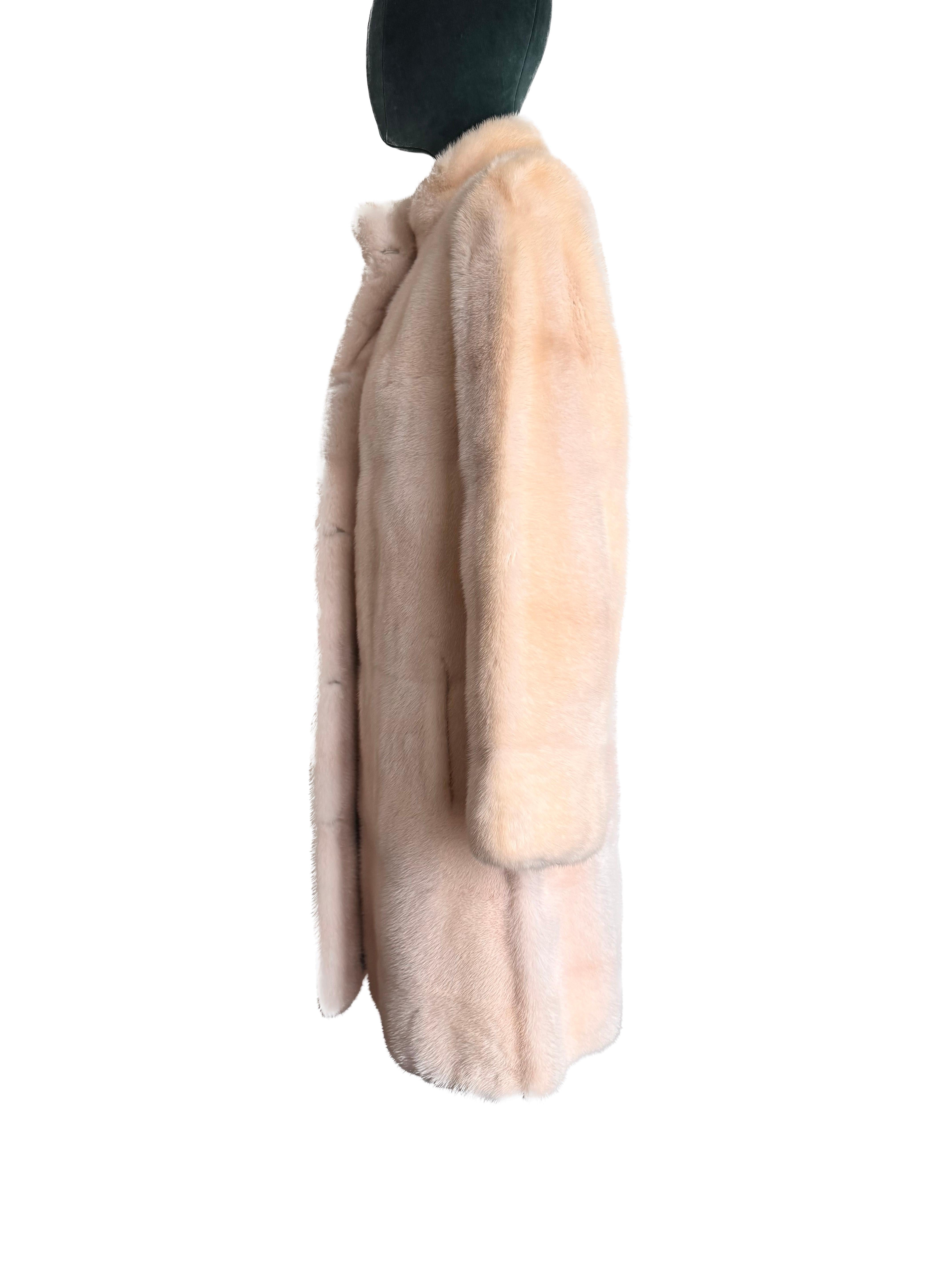 Indulge in the epitome of luxury and elegance with this exquisite natural pearl mink coat. Crafted to perfection, this brand new garment, complete with its original tags, presents a timeless allure and unparalleled sophistication. Designed in a