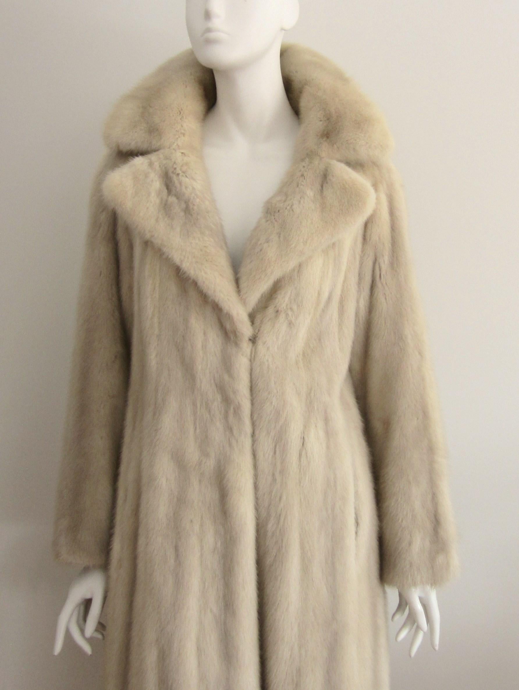 Stunning vintage pearl mink Coat. French hem, with 3 hook and eye closures and button at the neck. Will fit up to 10-12 But please compare measurements-Measures- Bust up to 38, Waist up to 42, Hips up to 50 Sleeve 23 in Fur is soft and supple. We