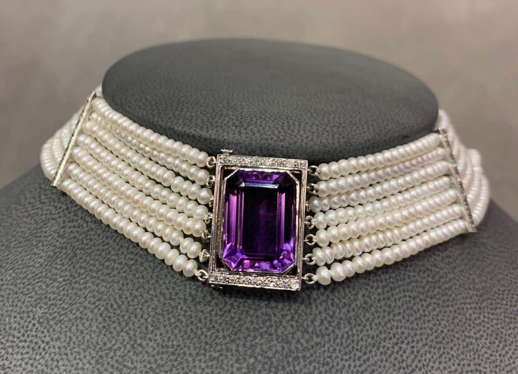 Pearl Multi Strand & Amethyst Choker Necklace,   7 strands of fresh water pearls forming  a choker necklace with 2 diamond spacers .  1  center amethyst approximately  15.41 carats.  30 small round cut diamonds approximately .38 carat  set in 14