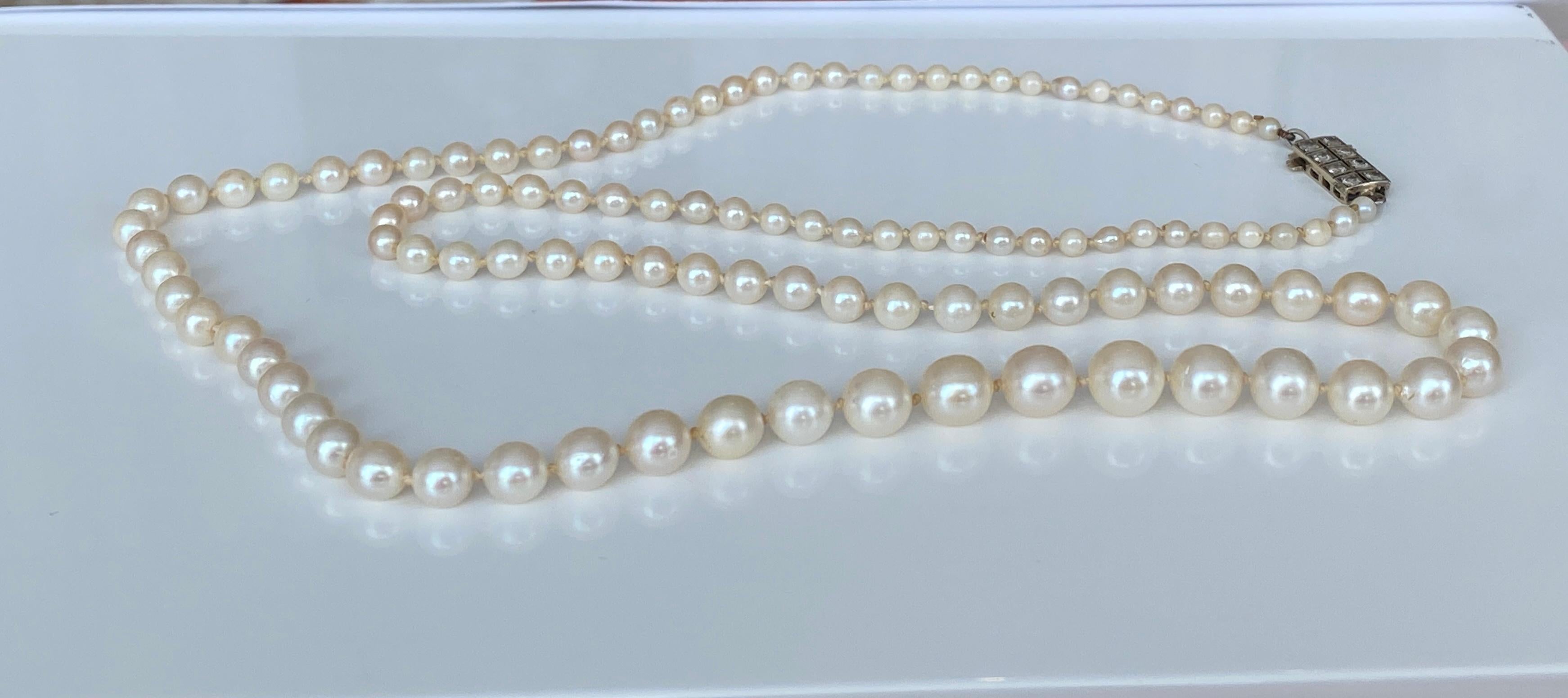 109 gleaming and luminous cultured Akoya pearls form this magnificent Art Deco-era necklace. The opera-length -20 inch- necklace is completed by a 18k yellow  gold clasp set with old-cut diamonds  The pearls range in size from 3.04mm to nearly