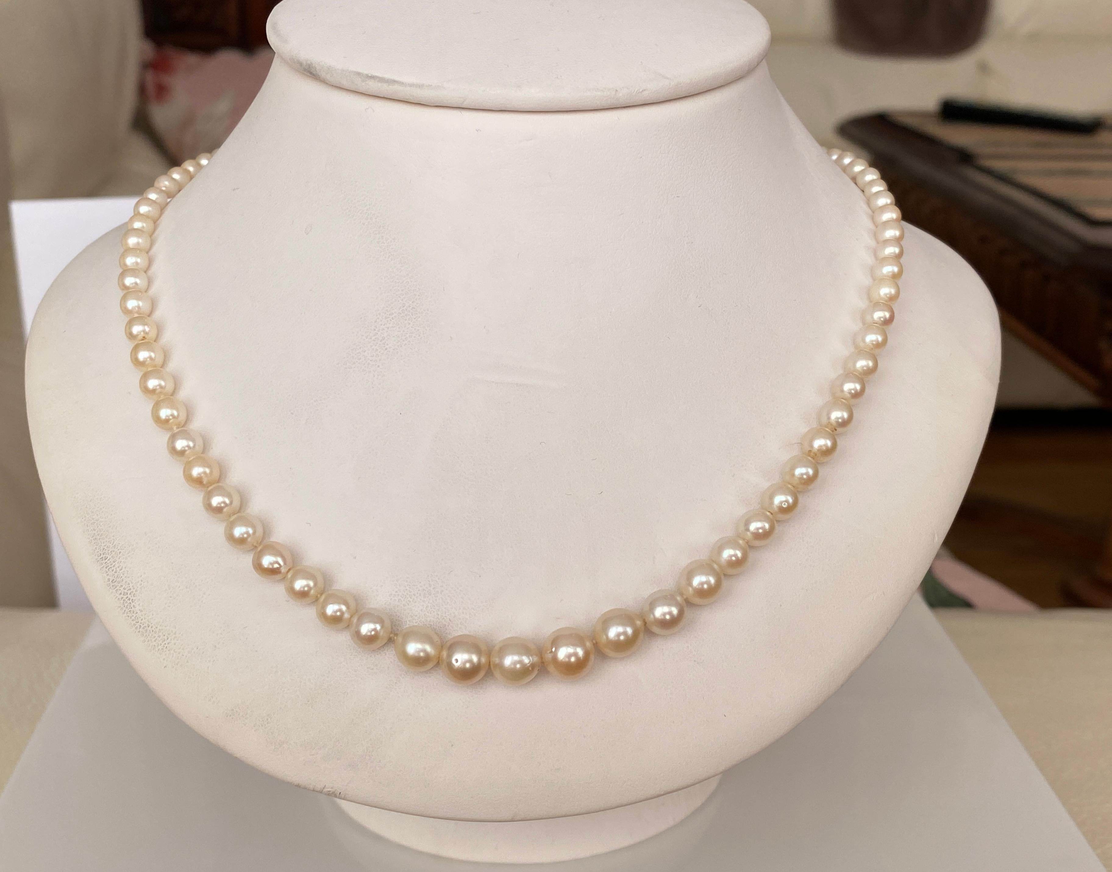 93 gleaming and luminous cultured Akoya pearls form this magnificent Art Deco-era necklace. The opera-length -20 inch- necklace is completed by a 18k yellow gold clasp set with old-cut diamonds  and onyx.  The pearls range in size from 3.21mm to