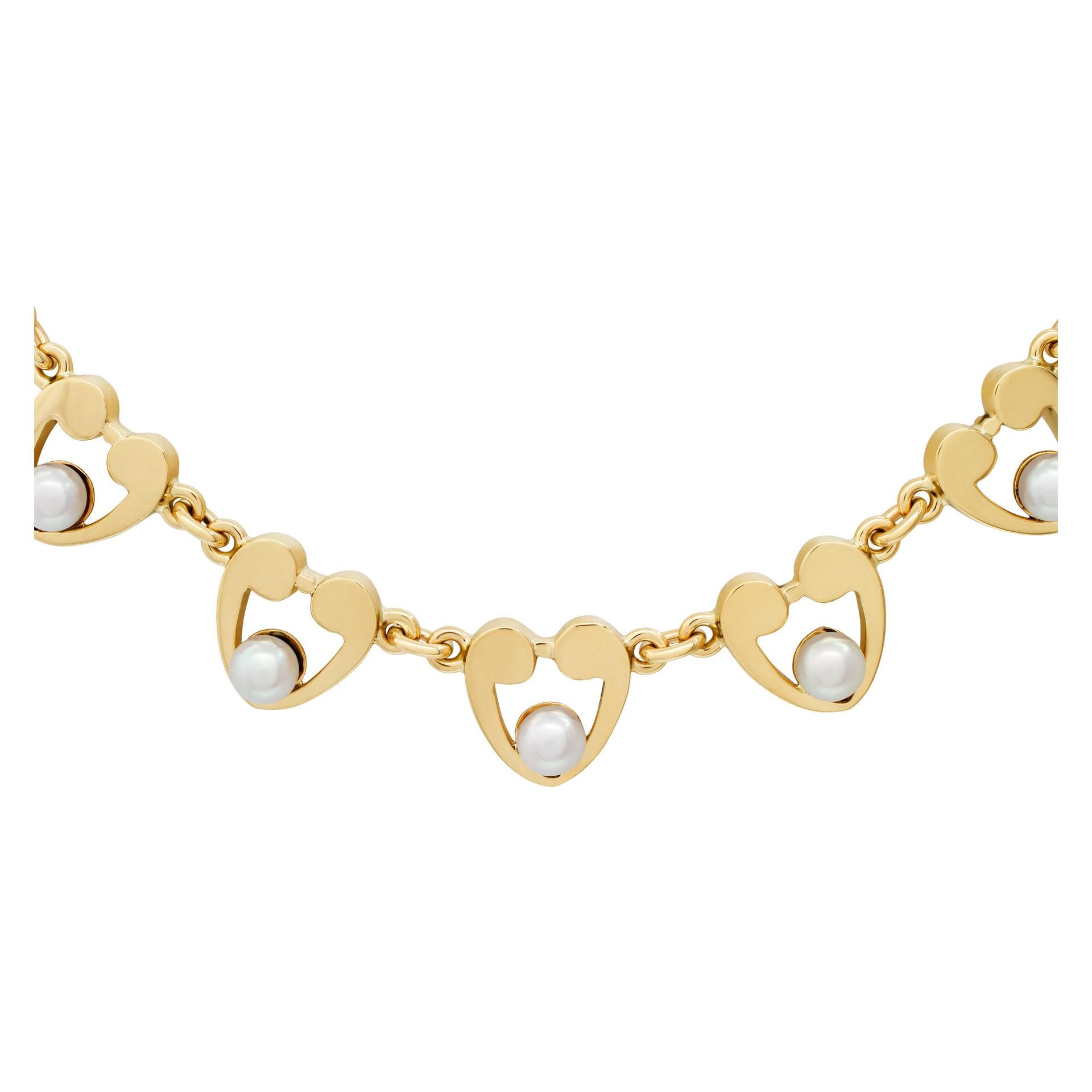 ESTIMATED RETAIL: $6,720 YOUR PRICE: $4,200 - Precious heart link choker necklace with 5mm pearls in 14k yellow gold. Length: 15''.