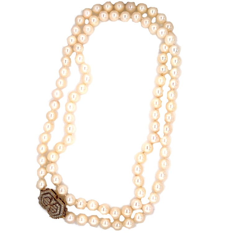 Circa: 1950
Metal Type: 14 karat yellow gold 
Length: 36 inches

Diamond Details:
Cut: Round
Color: G
Clarity: VS-SI
Carat: 1 Carat Total 

Each pearl is 8.5 millimeter 
The clasp is crafted in 14 karat gold with diamonds.
The necklace can be double