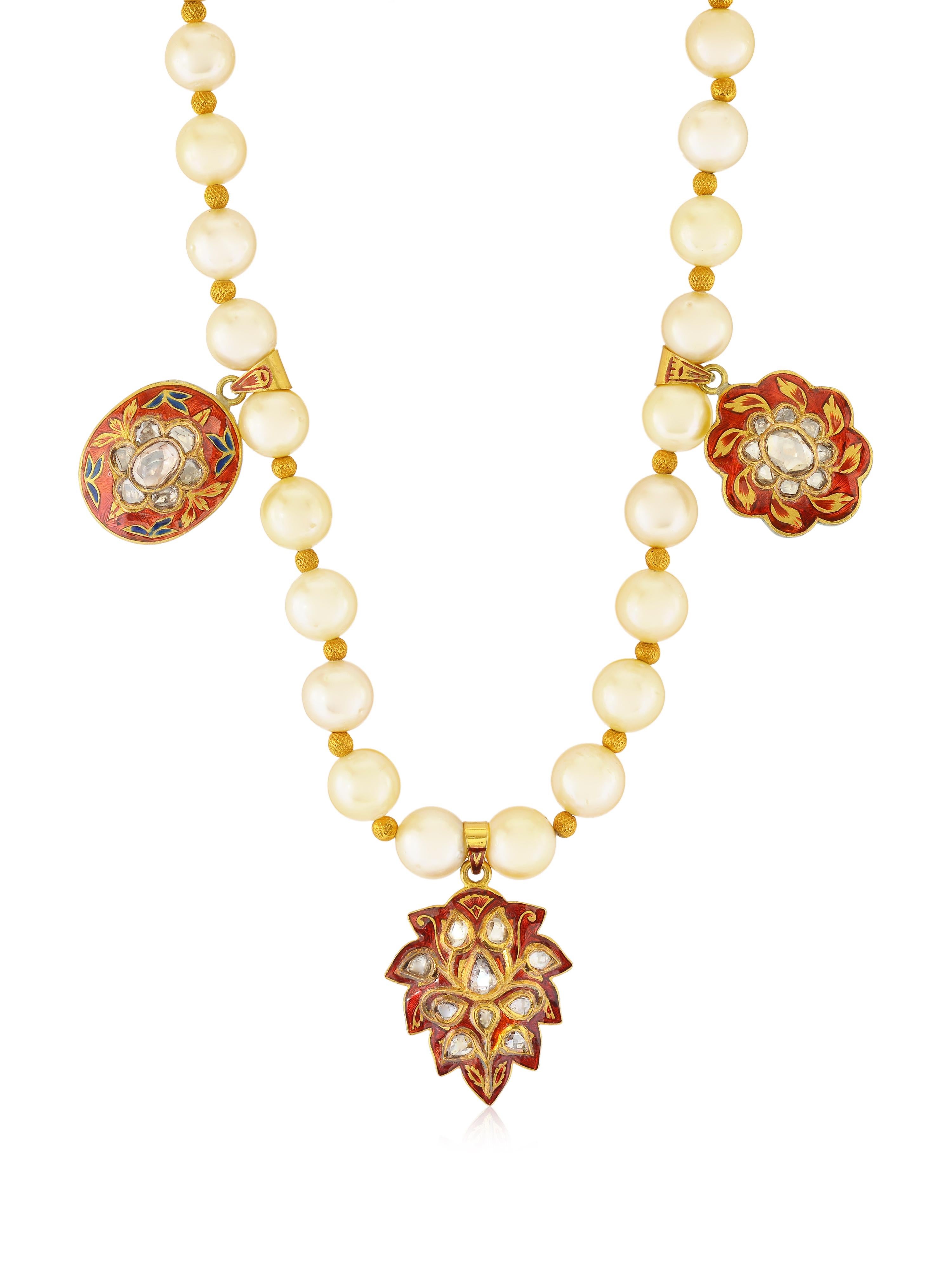 A beautiful pearl necklace with 3 pendants with enamel work and diamonds. It's a clssic necklace suitable for all occasions. The Pendants are all handmade with traditional Indian Enamel work called 