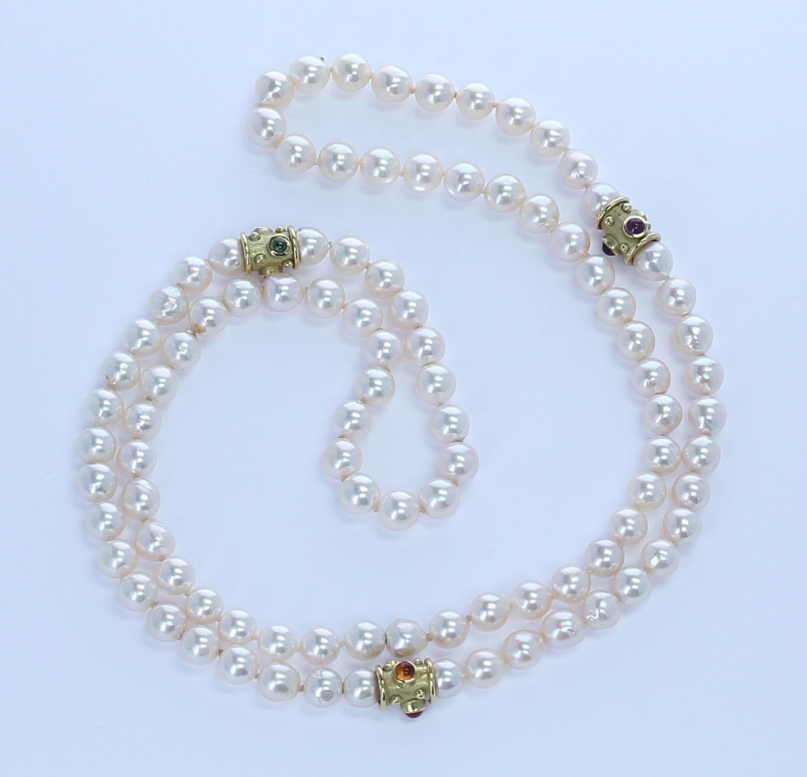 A classic strand of smooth cultured pearls with Gold and Semi-Precious Cabochon Spacers-Peridot, Citrine, Amethyst. Weight: 458 cts. Range: 8MM, Length: 34 inches