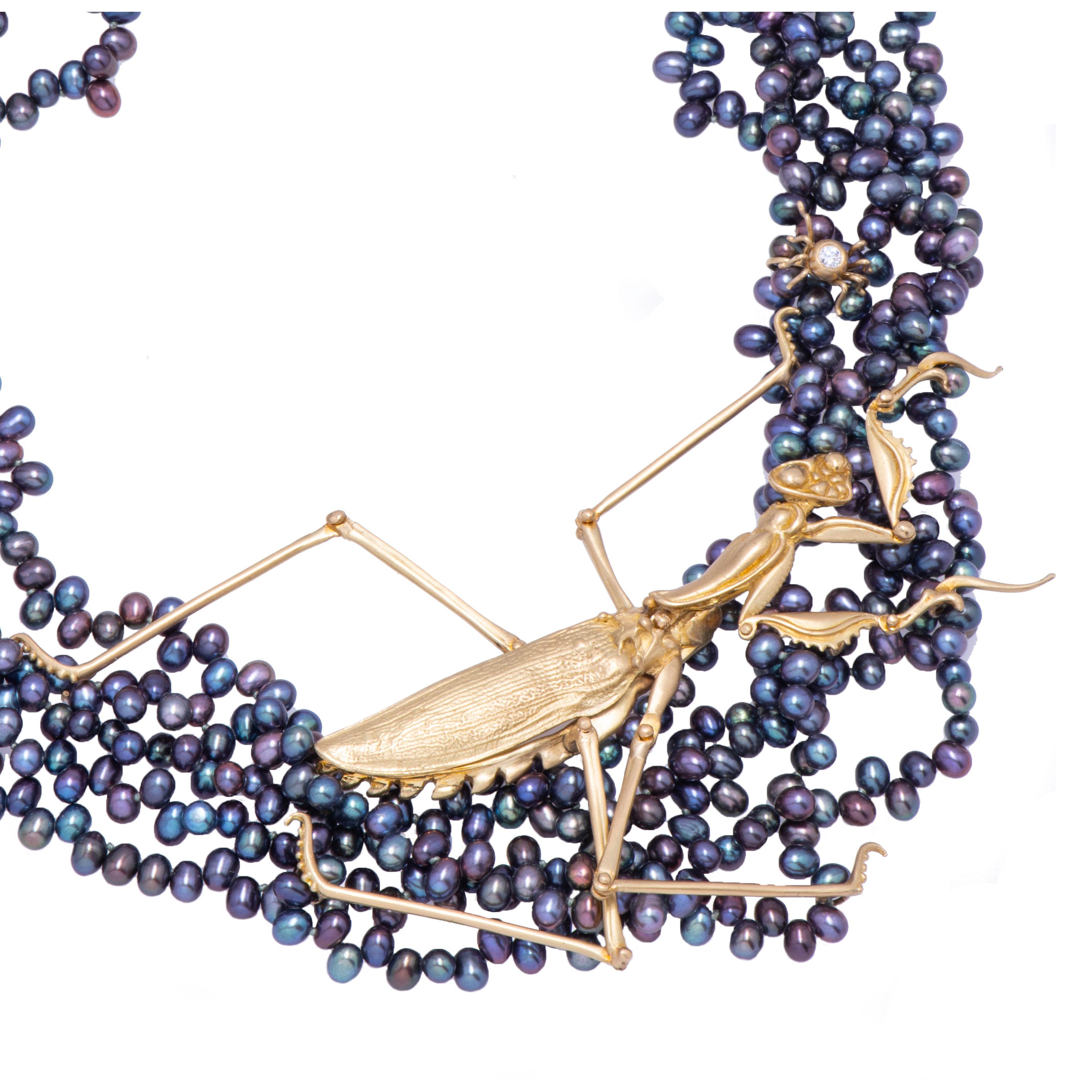 An 18 karat gold praying mantis tip toes across 5 strands of blue/purple Chinese freshwater pearls reaching delicately for an 18 karat gold spider set with a .15 carat diamond in this Pearl Necklace with Mantis. Fixed slightly to the right of